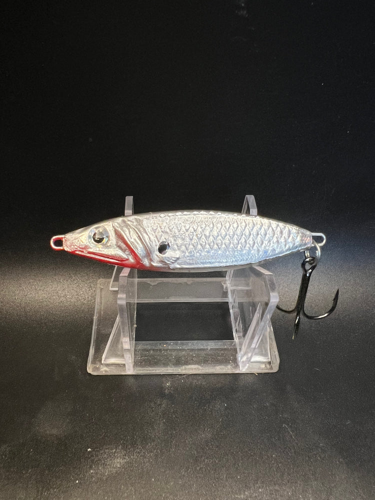 Lamprey Of God UV 1.25 oz salmon jigging spoon in silver with red accents, on stand