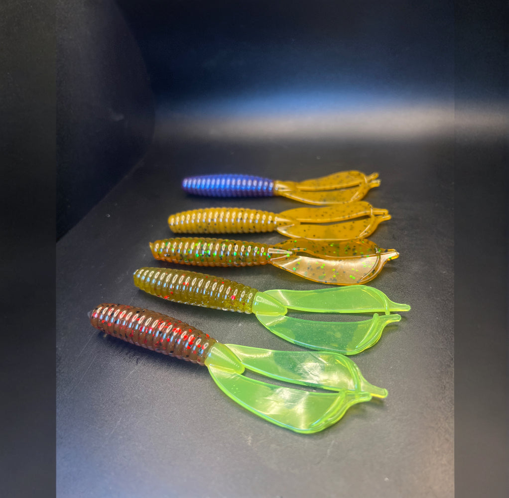 Soft plastic crayfish lures in green, yellow, and red-speckled bodies