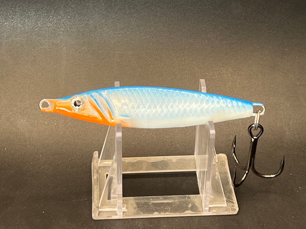 Orange-and-silver UV jigging spoon lure with treble hooks