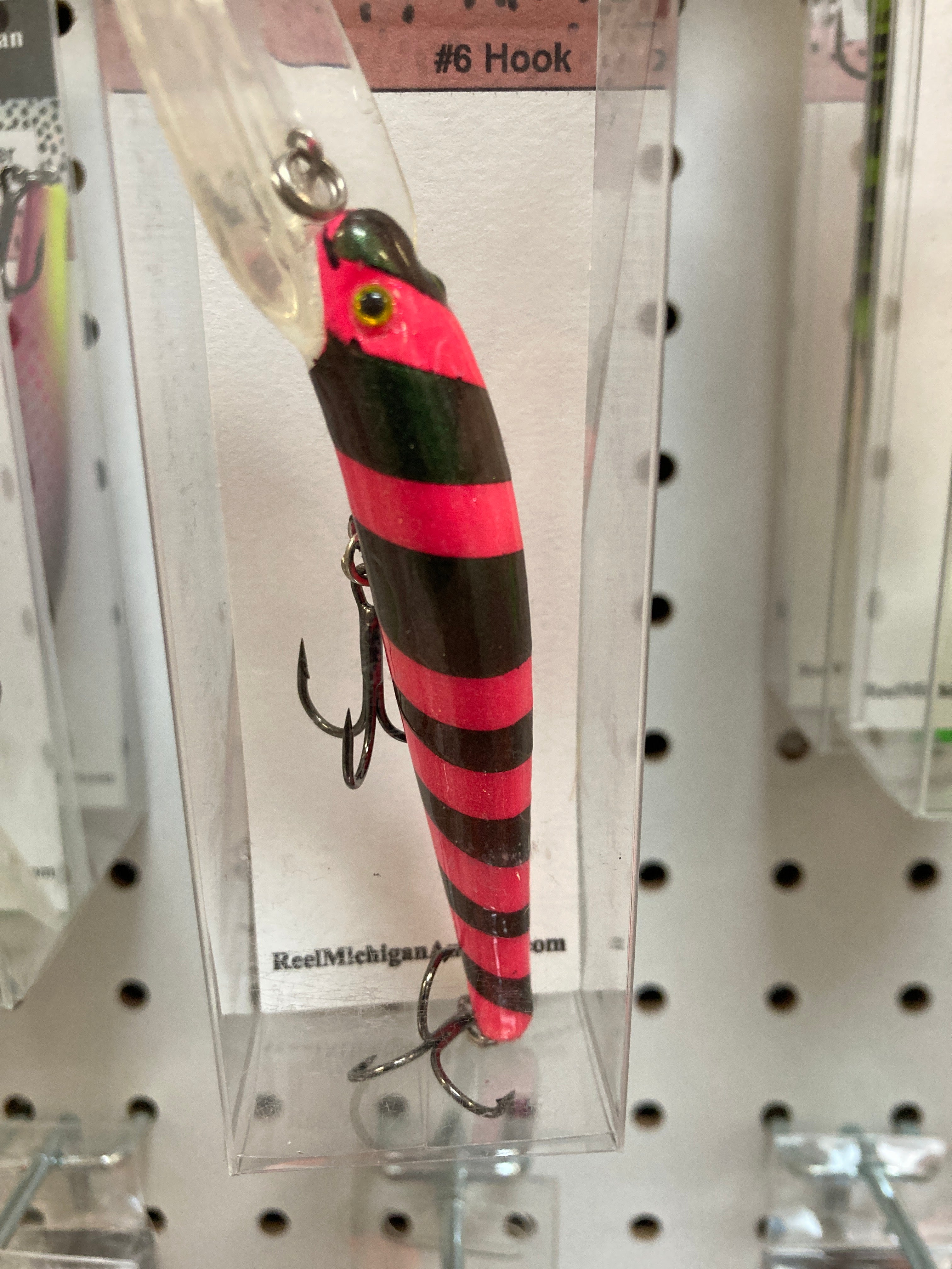 Black, red, and green striped fishing lure with #6 hook and treble hooks.