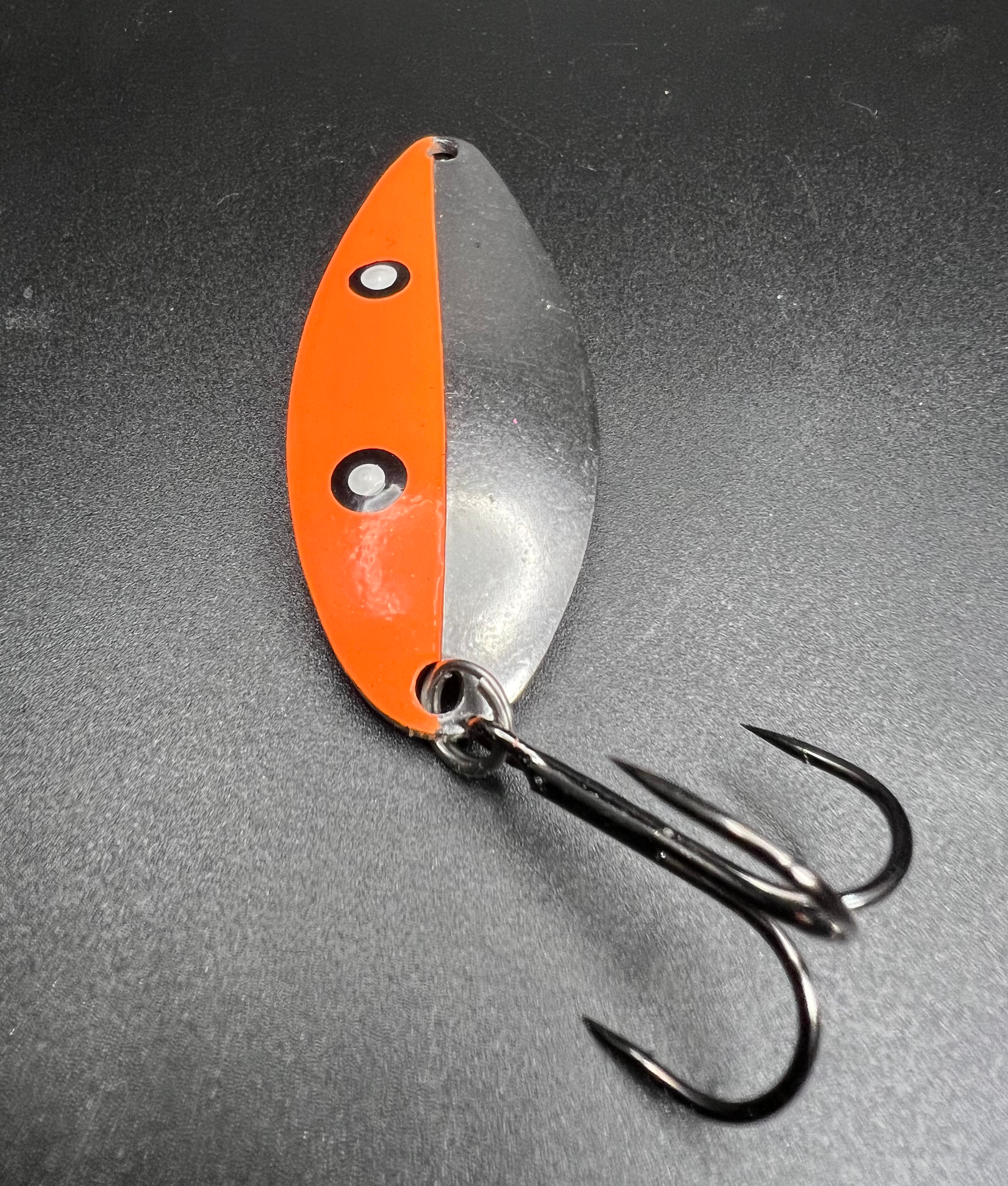 Atom Bomb Little Cletus orange/silver fishing lure with two treble hooks