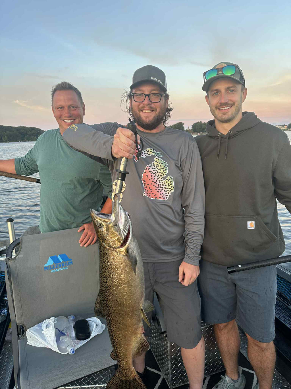 Fish on a boat with a jigging spoon lure visible at the mouth