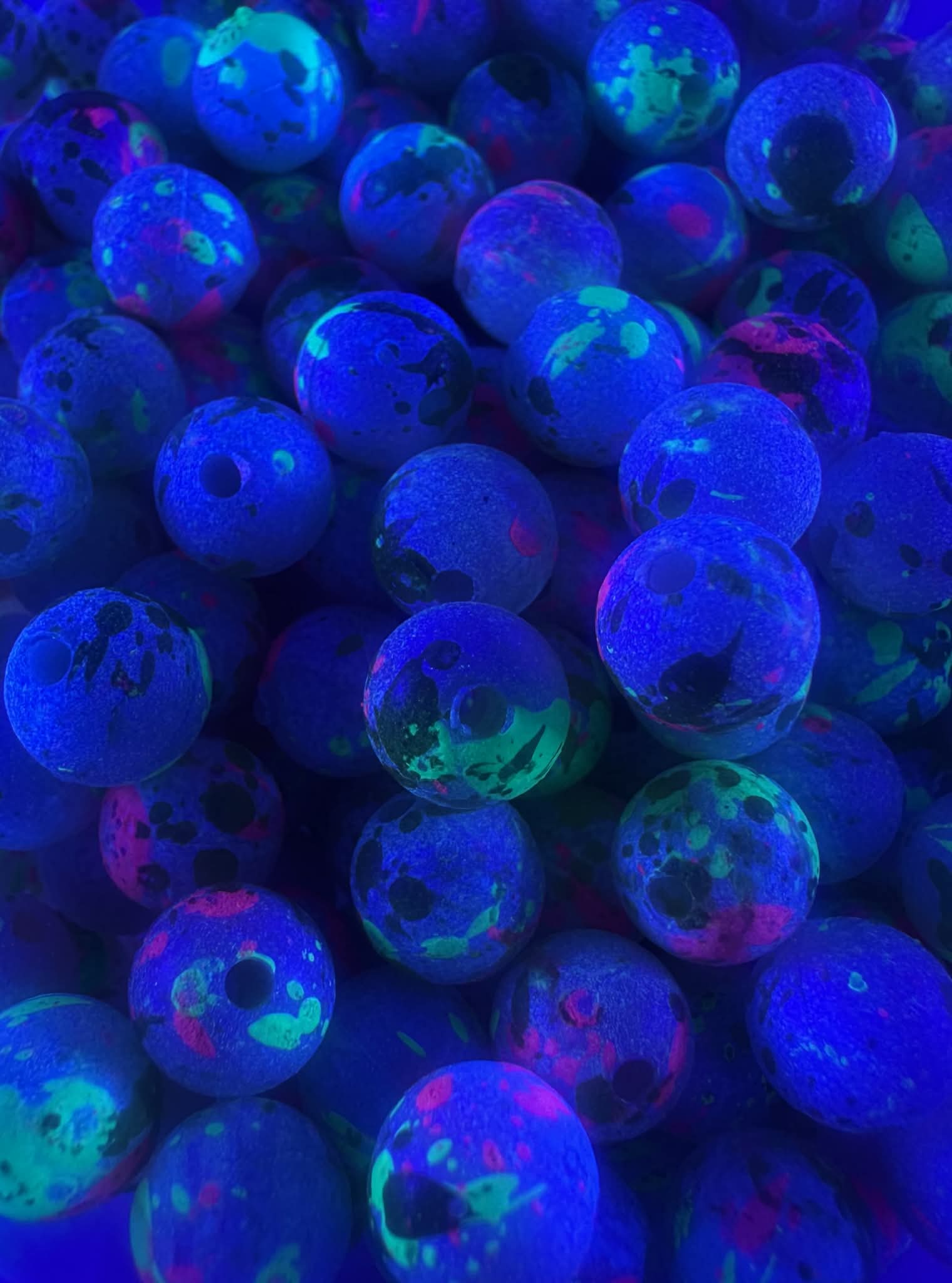 UV glow fishing beads: blue glowing round beads with neon green and pink specks