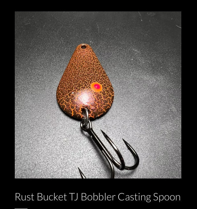 RMA casting spoon with rust-brown speckled body and treble hooks