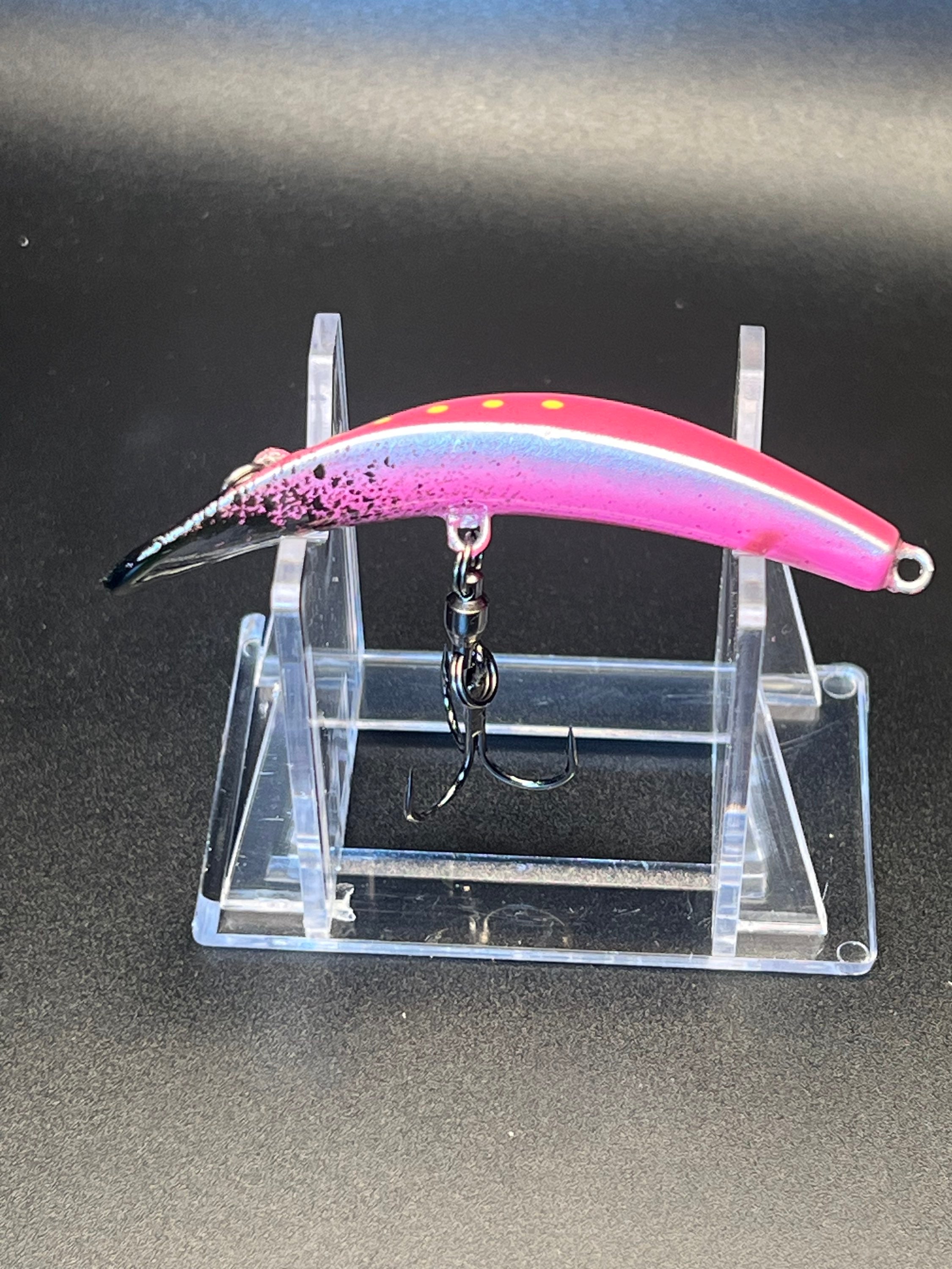 Pink and black UV Swiftfish lure with yellow dots and silver front eye, side view