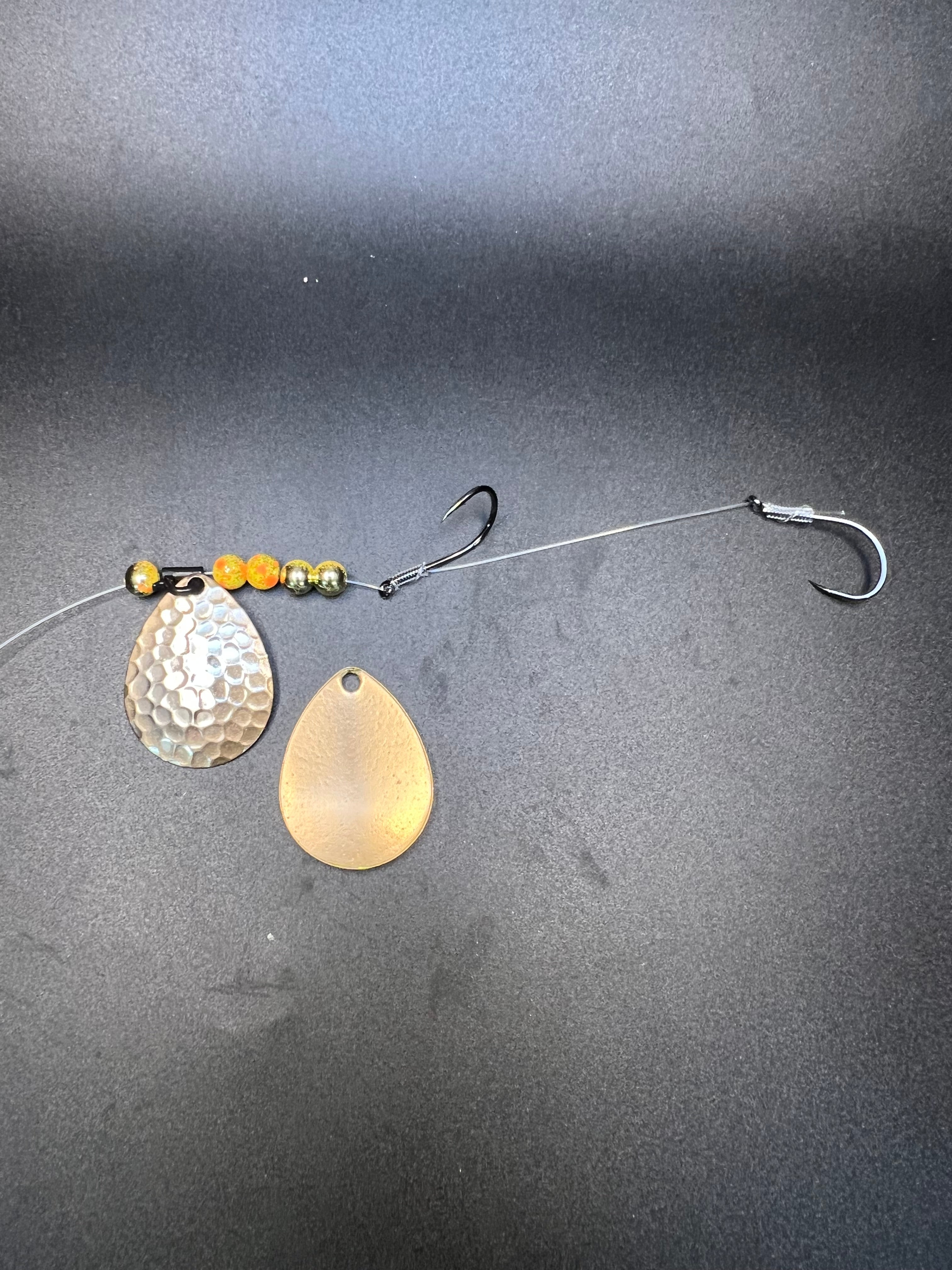 Fishing crawler harness with two gold spoon blades, bead string, and wire hooks