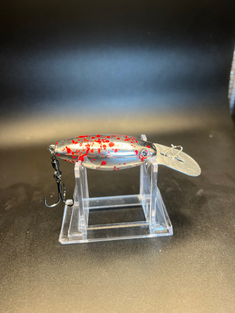 The Butcher UV trolling plug with red speckled pattern and treble hook