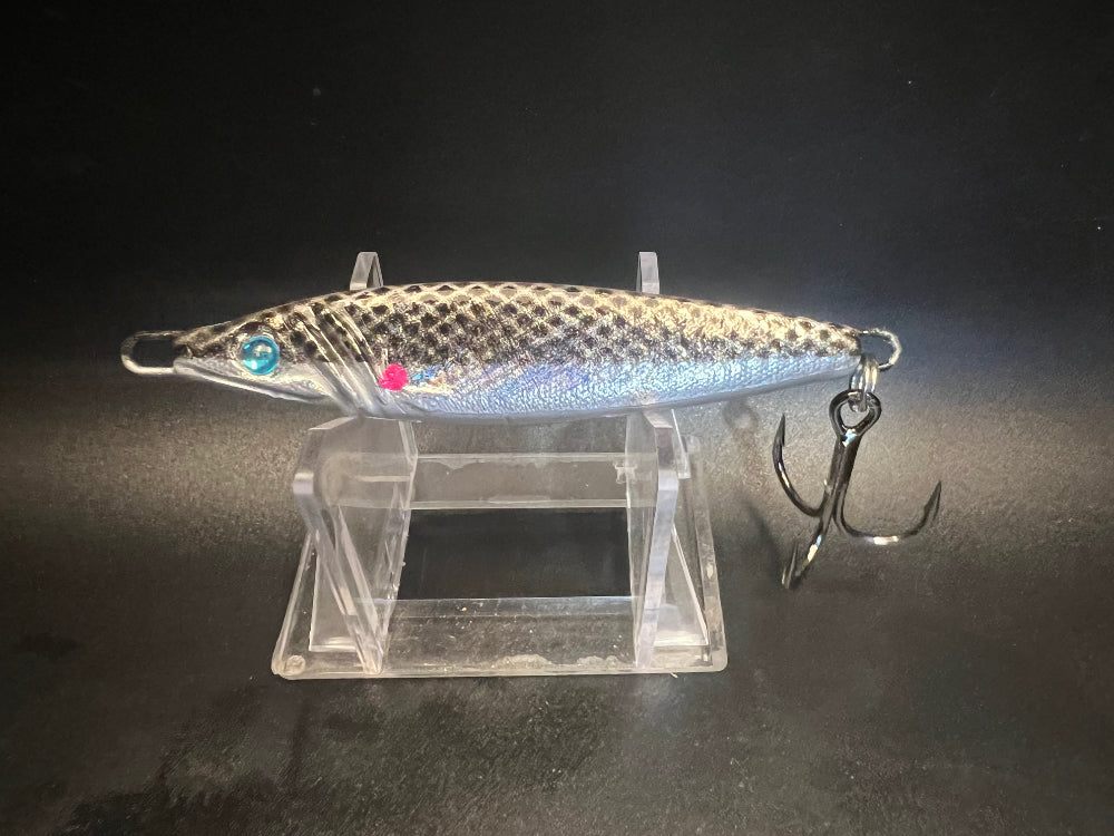 Talking Sheepheads UV 2 oz jigging spoon, silver-blue body with blue eye and treble hook