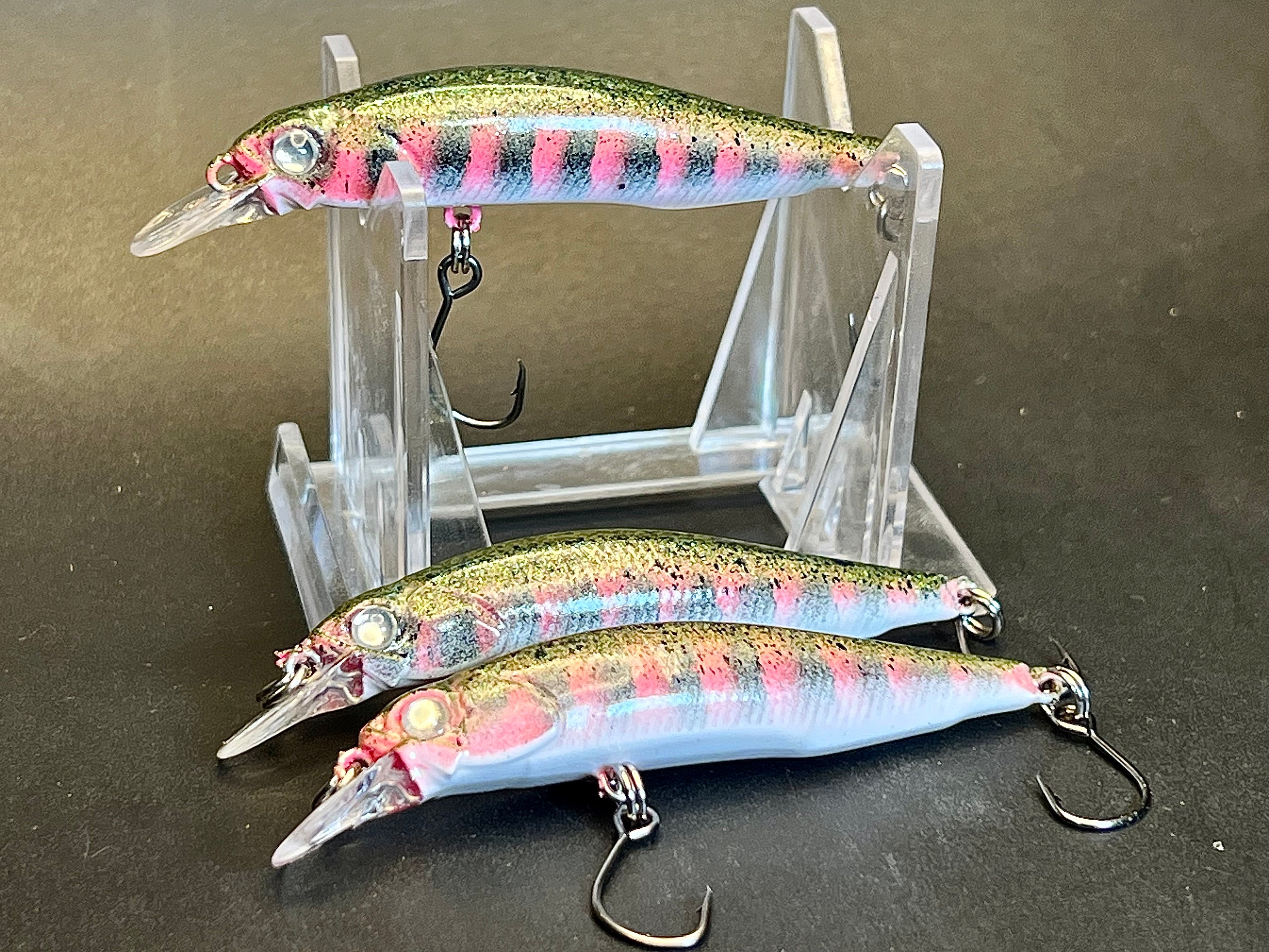 Multi-color minnow-style jerkbait lures with treble hooks for shallow slow-sinking