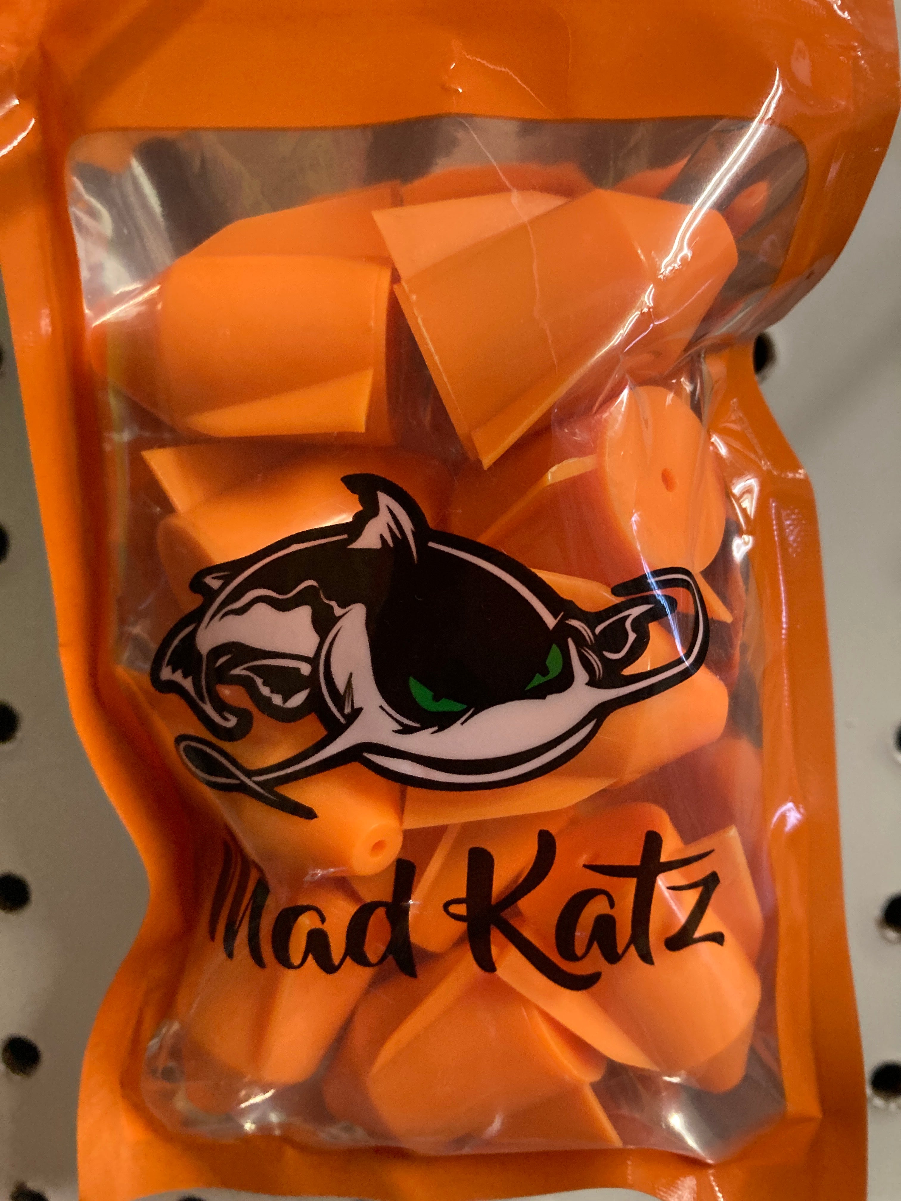 Orange rocket rattle toy with cat graphic, packaged in clear sleeve