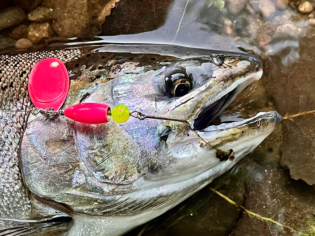 Chrome inline spinner lure with red/pink blade, yellow bead, and treble hook