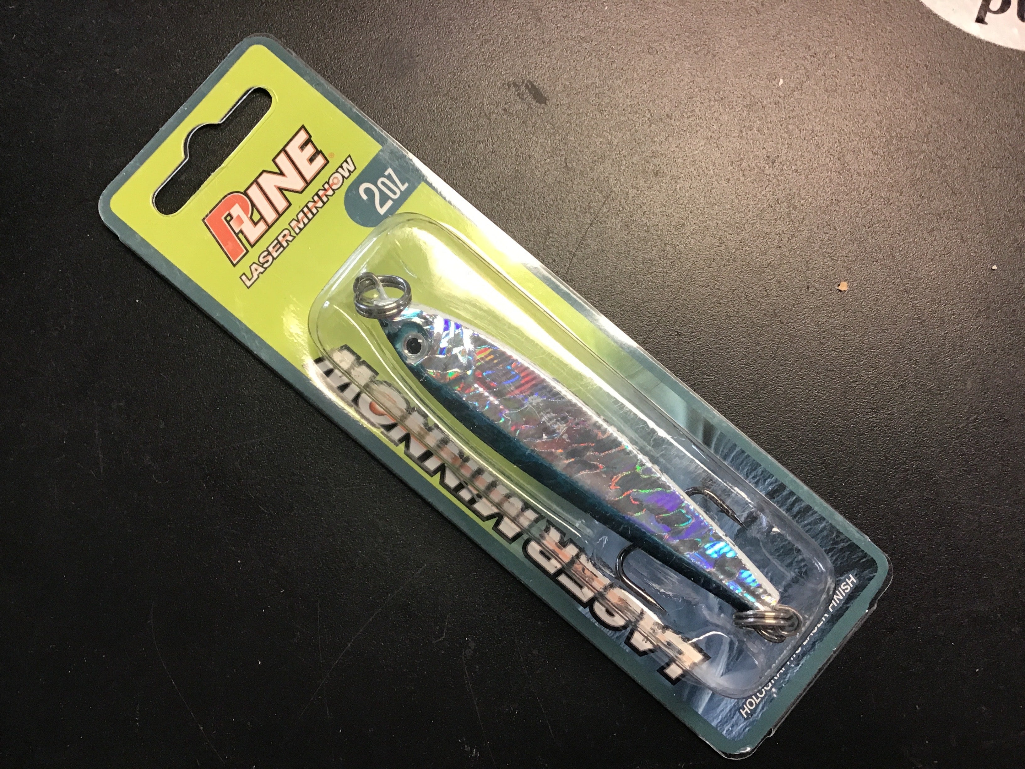 Holographic silver and blue jigging spoon with dark top and chrome hook