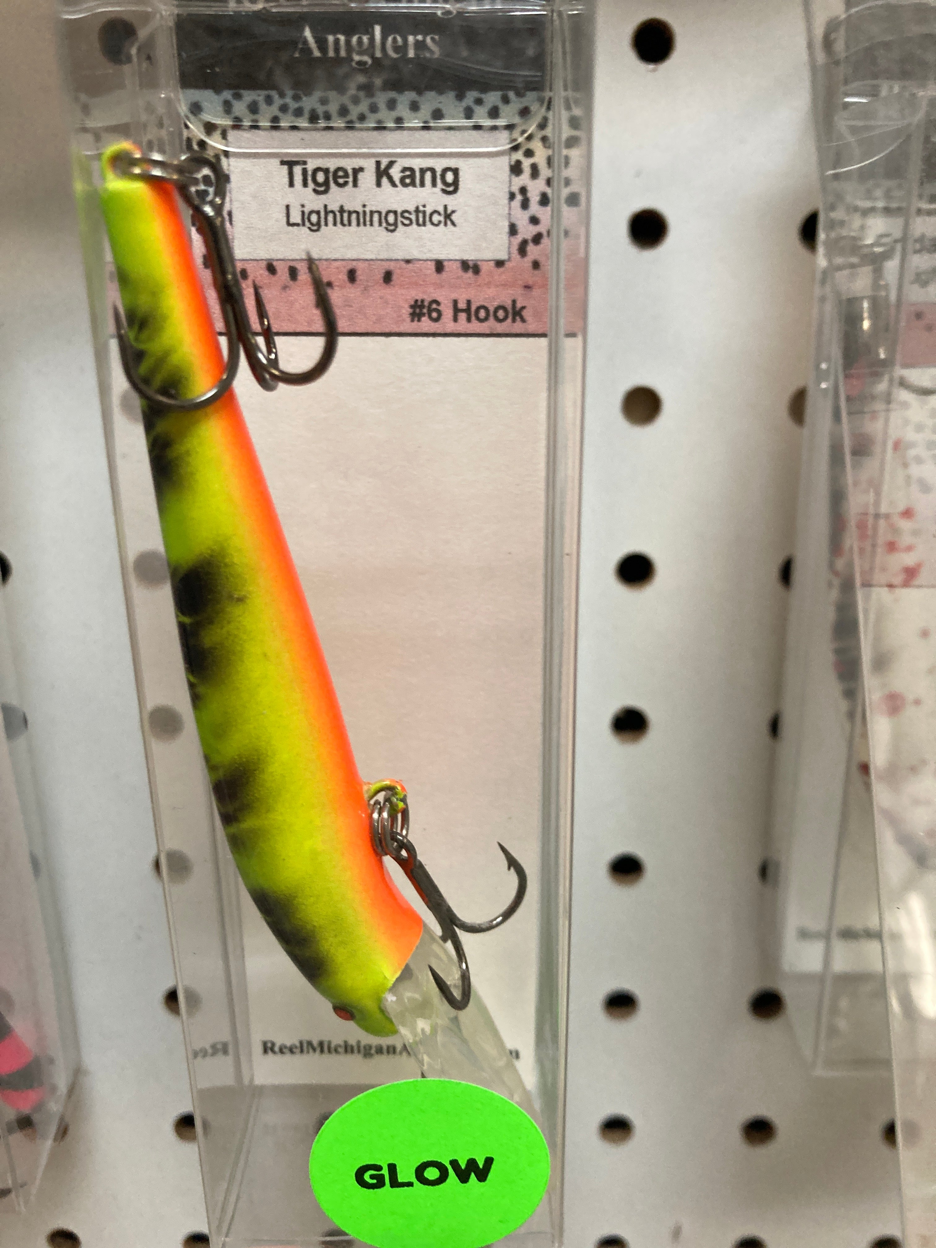 Neon green and orange striped fishing lure with #6 hook and two treble hooks.
