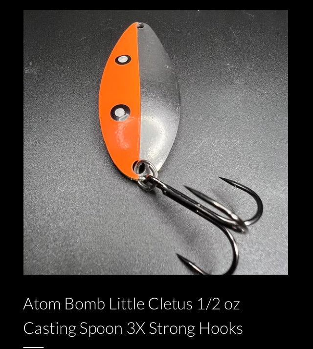 Orange and silver casting spoon with three treble hooks