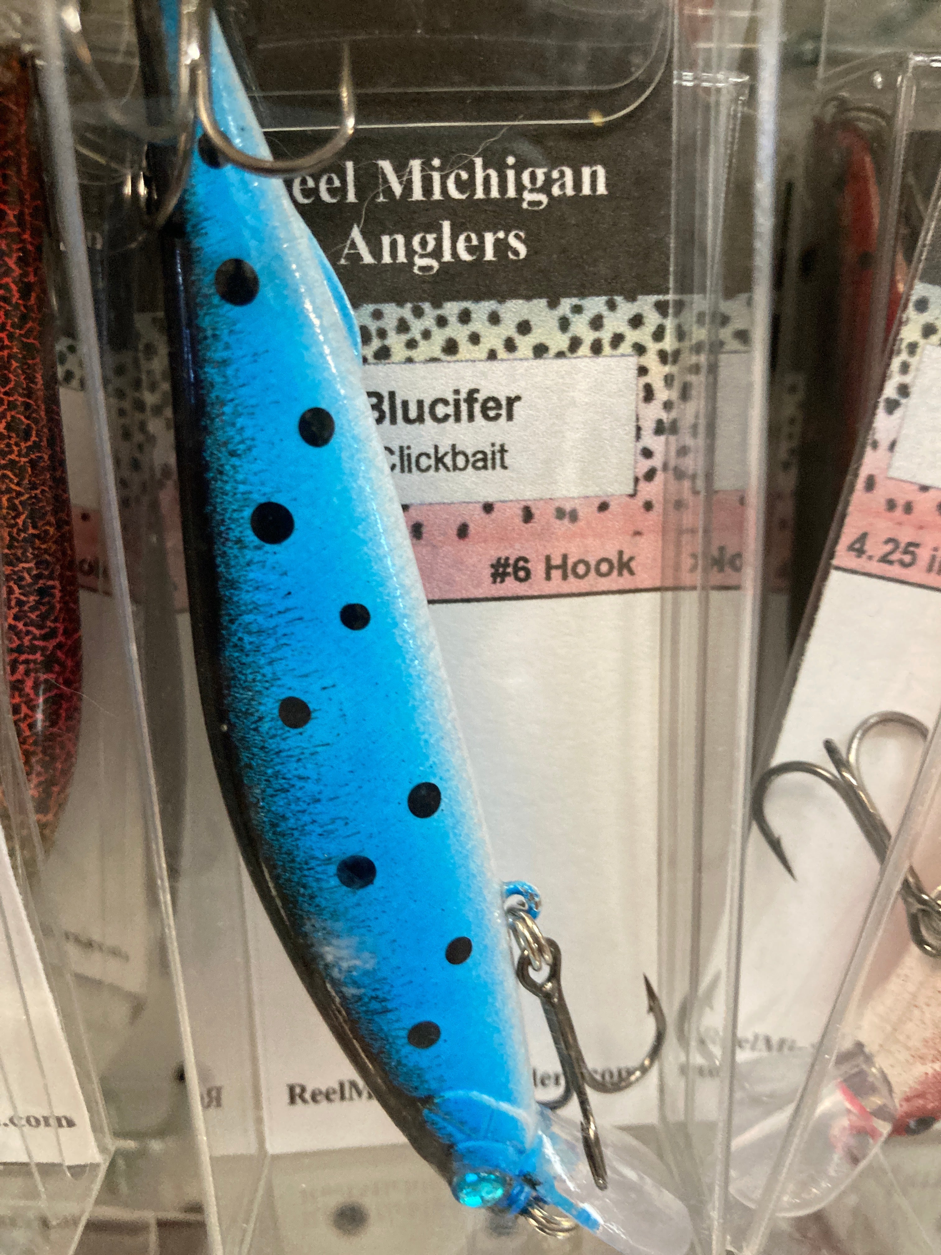 Blue fishing lure with dark dot pattern, treble hooks, 4.25 in.