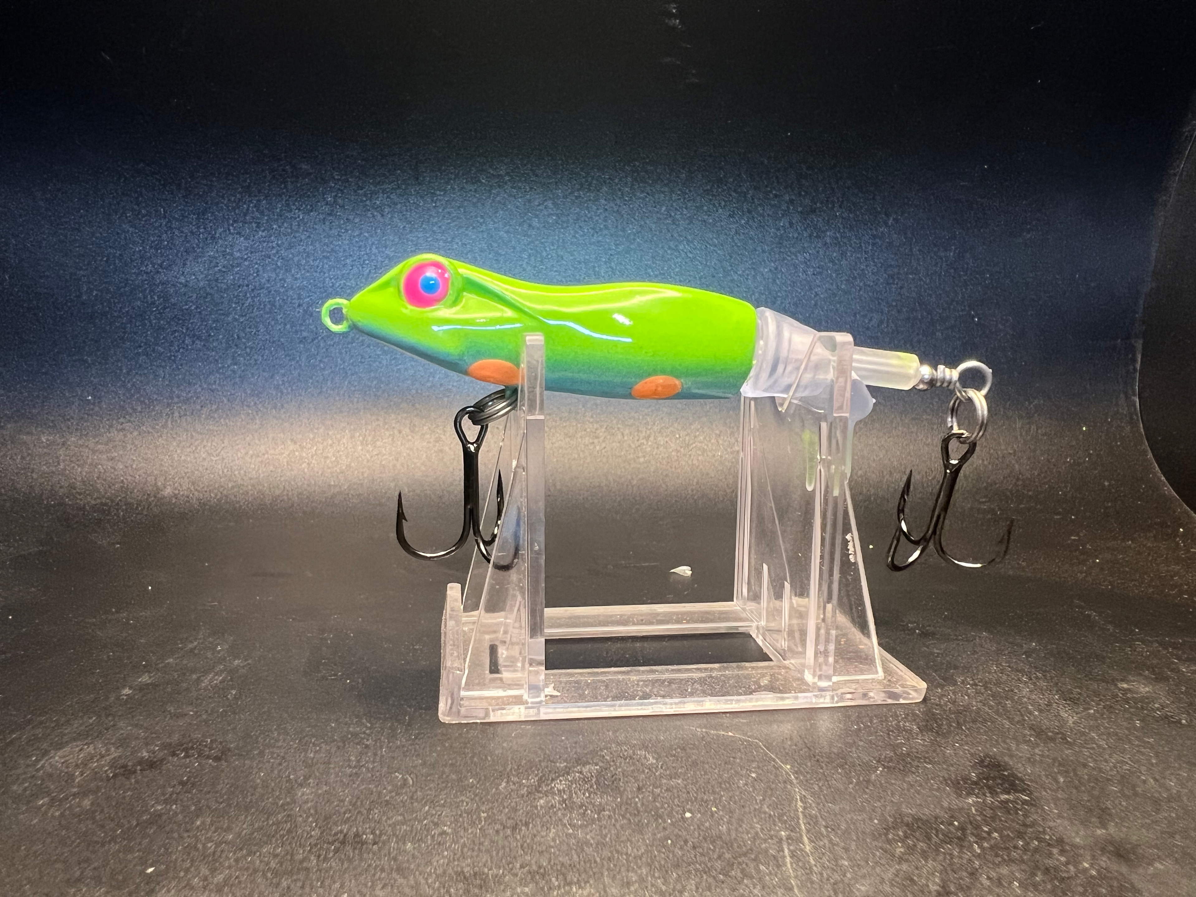 90mm popper lure in neon green with 3 treble hooks on clear stand