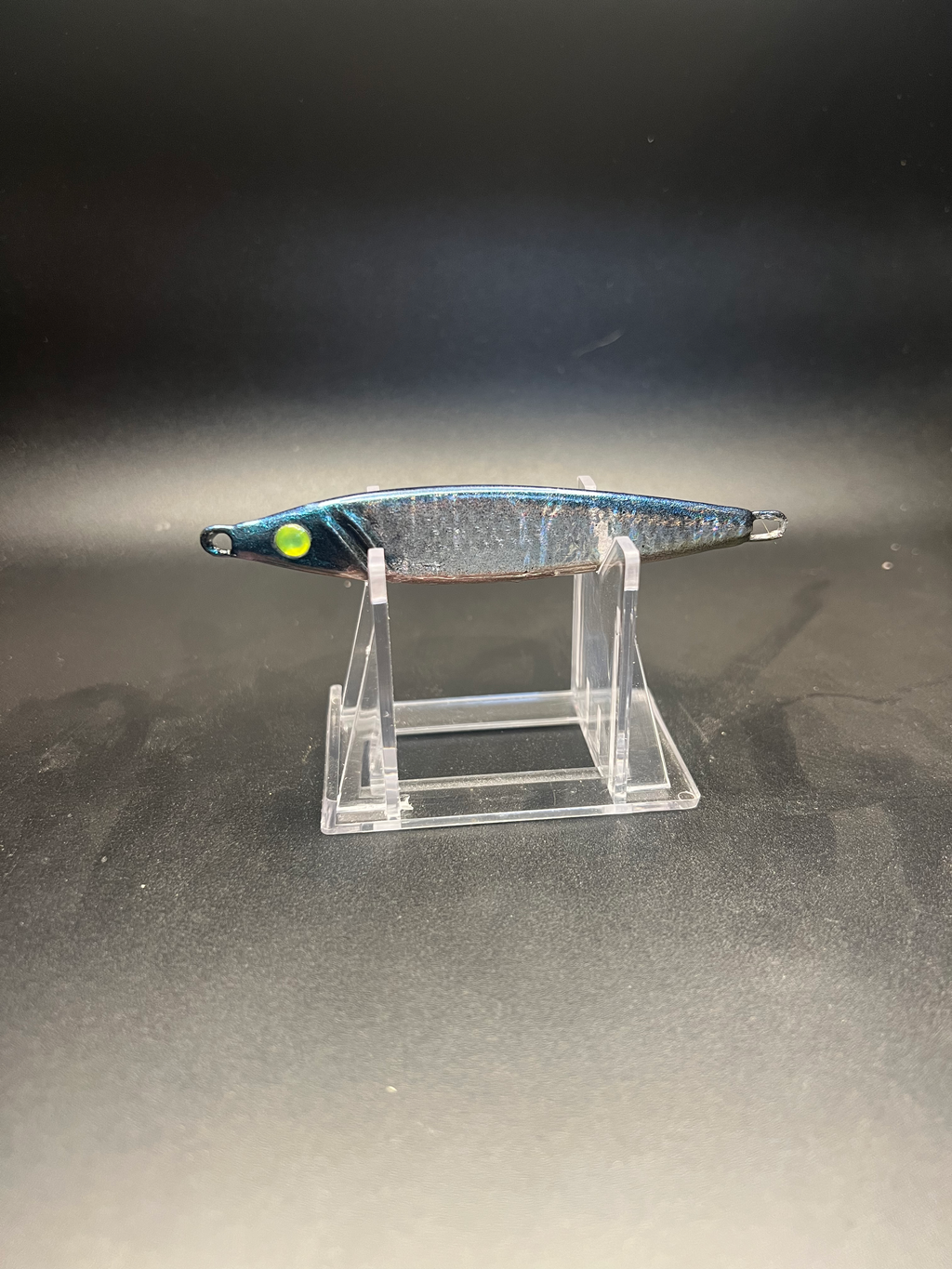 UV 2 oz jigging spoon, silver finish with green-yellow eye and front treble hook