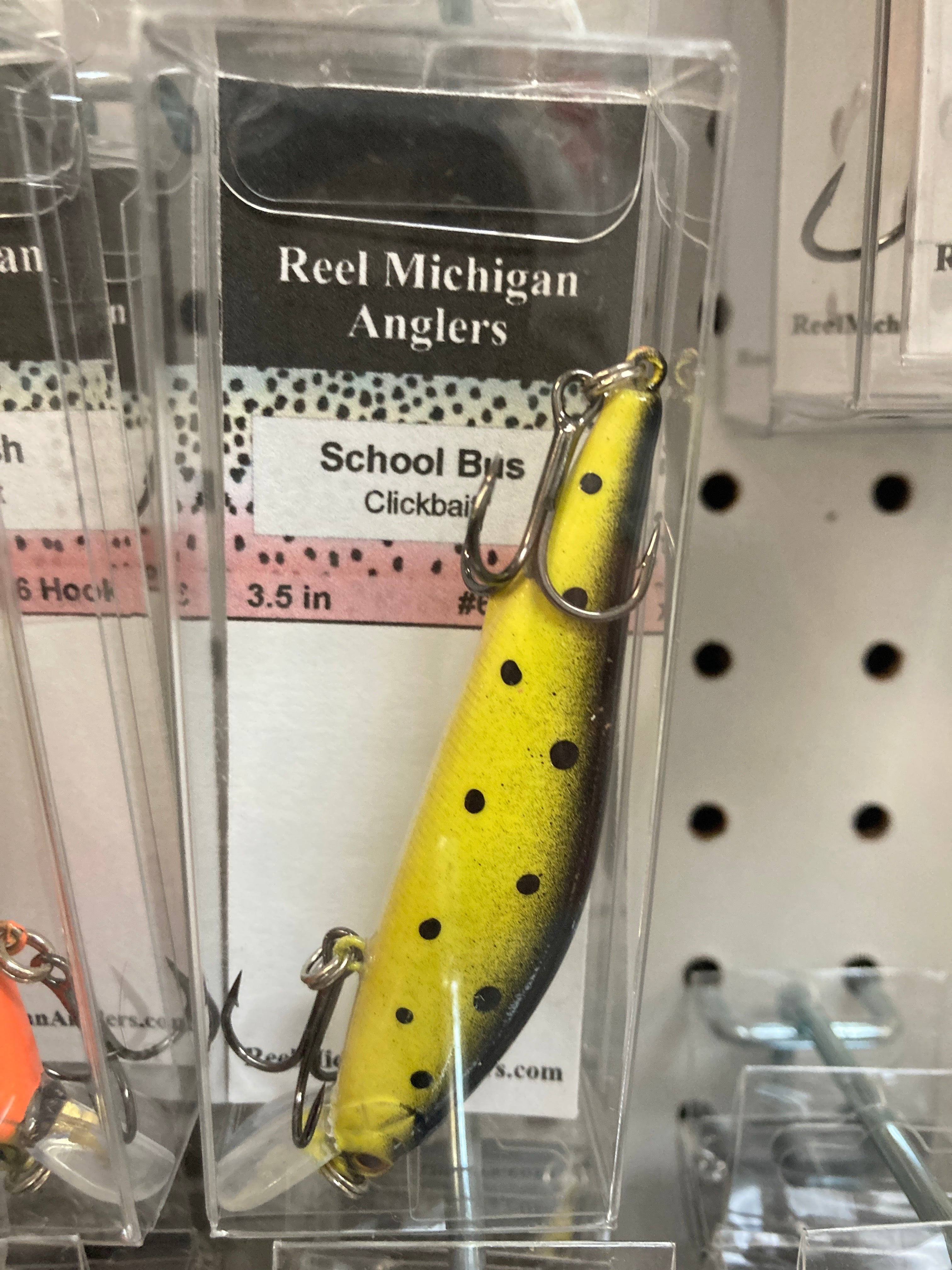 Fishing lure with yellow school-bus paint, black dot pattern and treble hook