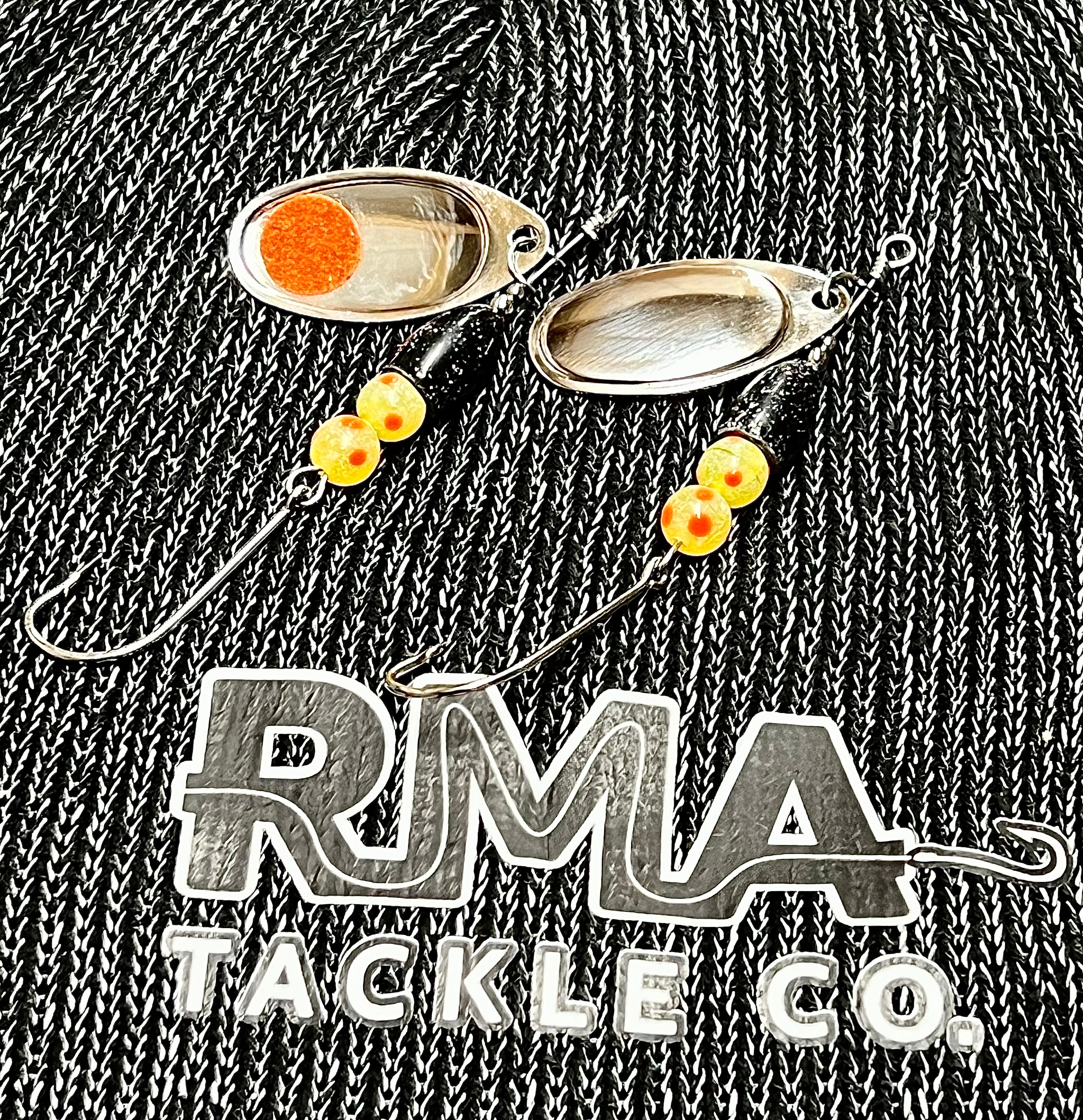 Two oval silver inline spinner lures with orange inserts and dangling beads