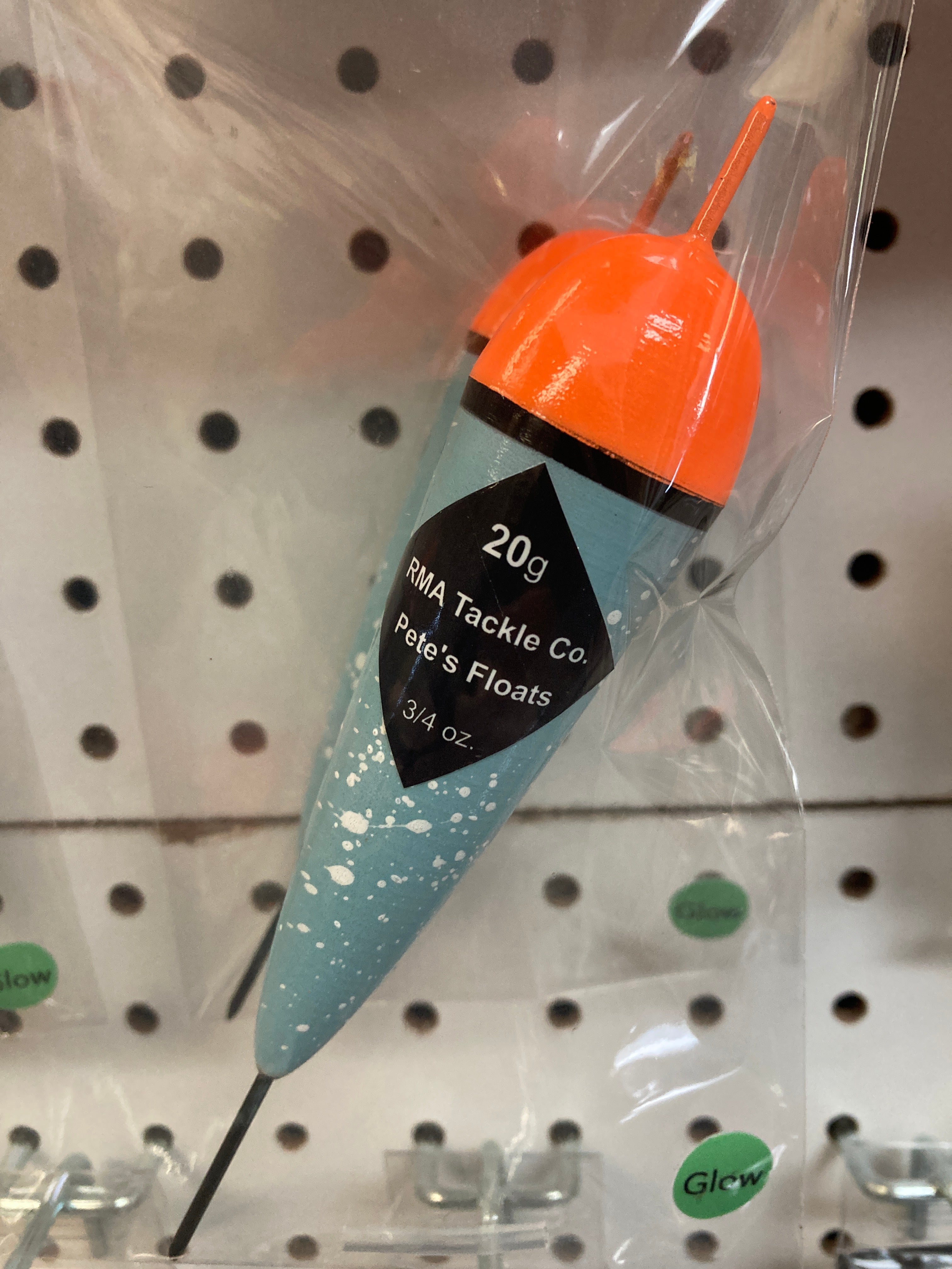 Glow-in-the-dark fixed fishing float, orange top and teal speckled body in clear bag