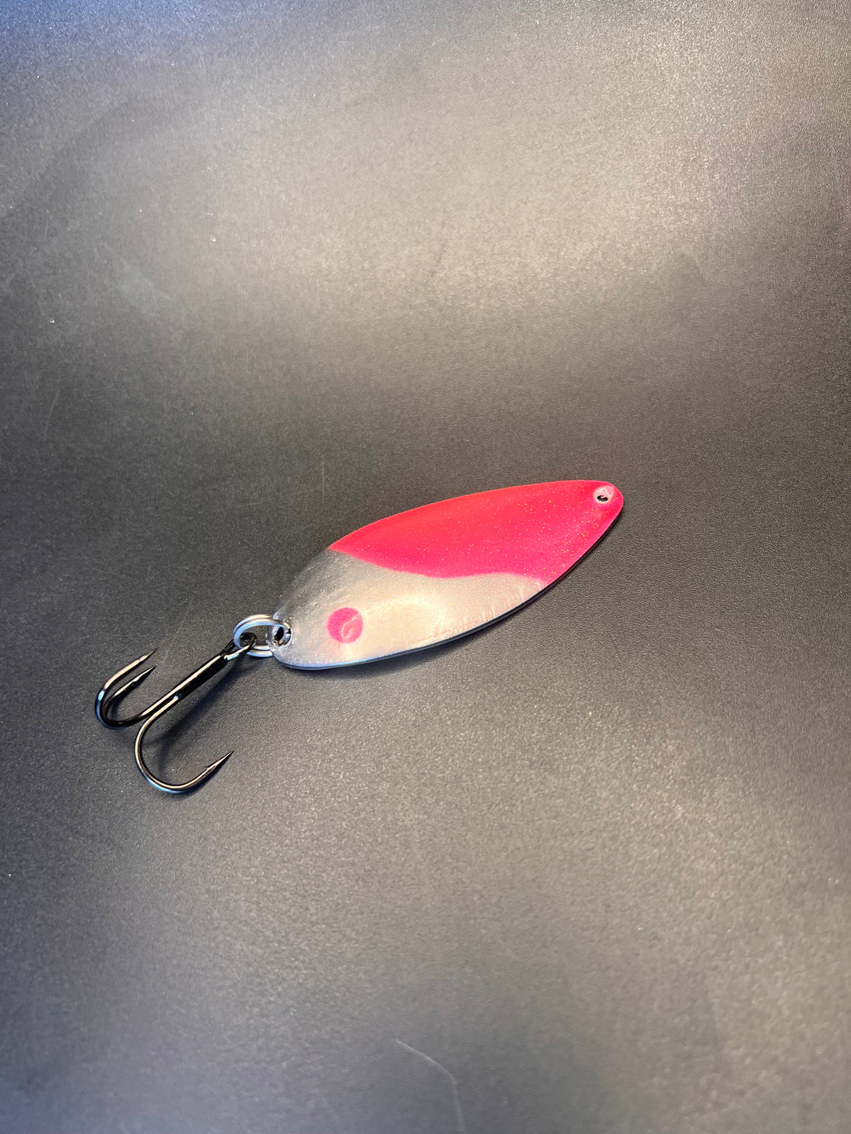 Pink and silver fishing casting spoon with treble hooks