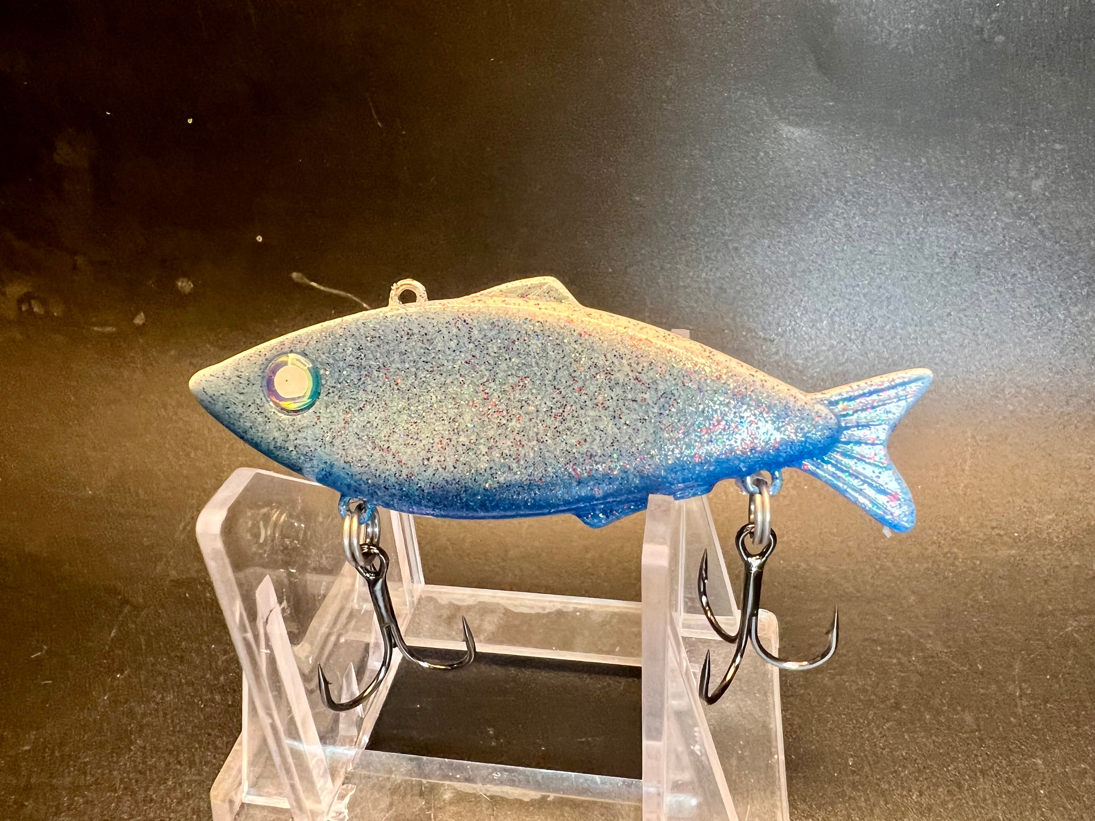 Rumplefishskin fishing lure with blue speckled body, single top loop, two treble hooks