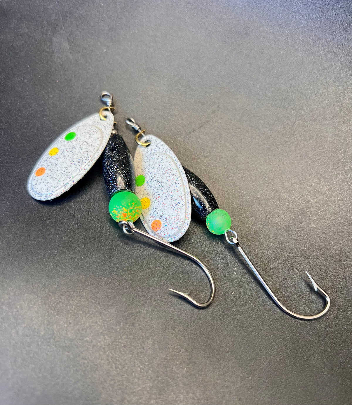 Snow Monster Chrome Crusher inline spinner fishing lure with glitter blades, green beads, and hooks