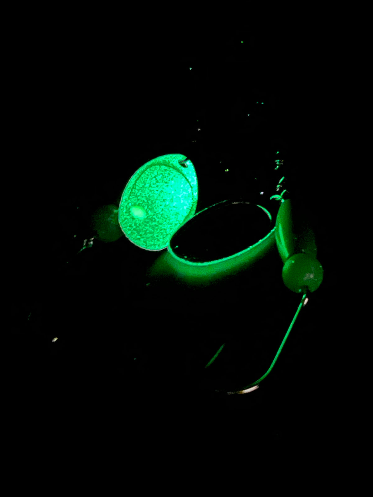 Glow-in-the-dark inline spinner with green blades and treble hooks