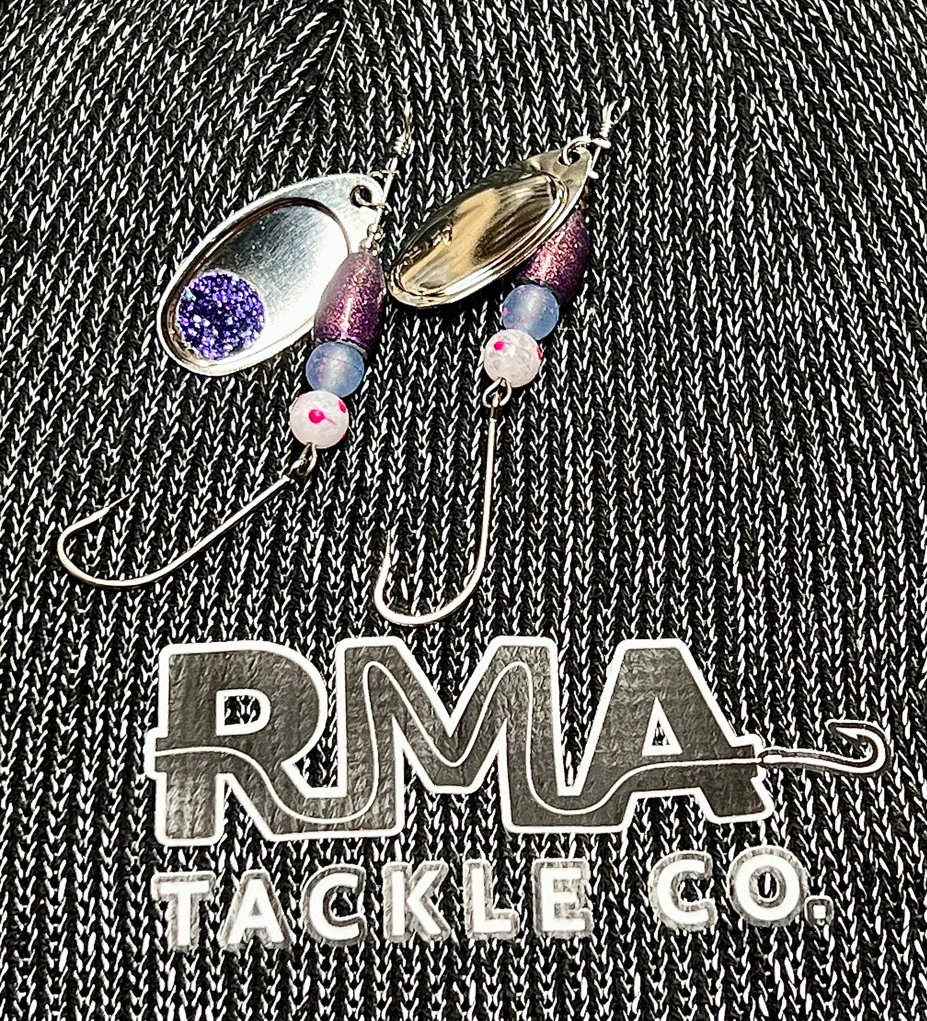 Inline spinner fishing lure with purple and silver blades