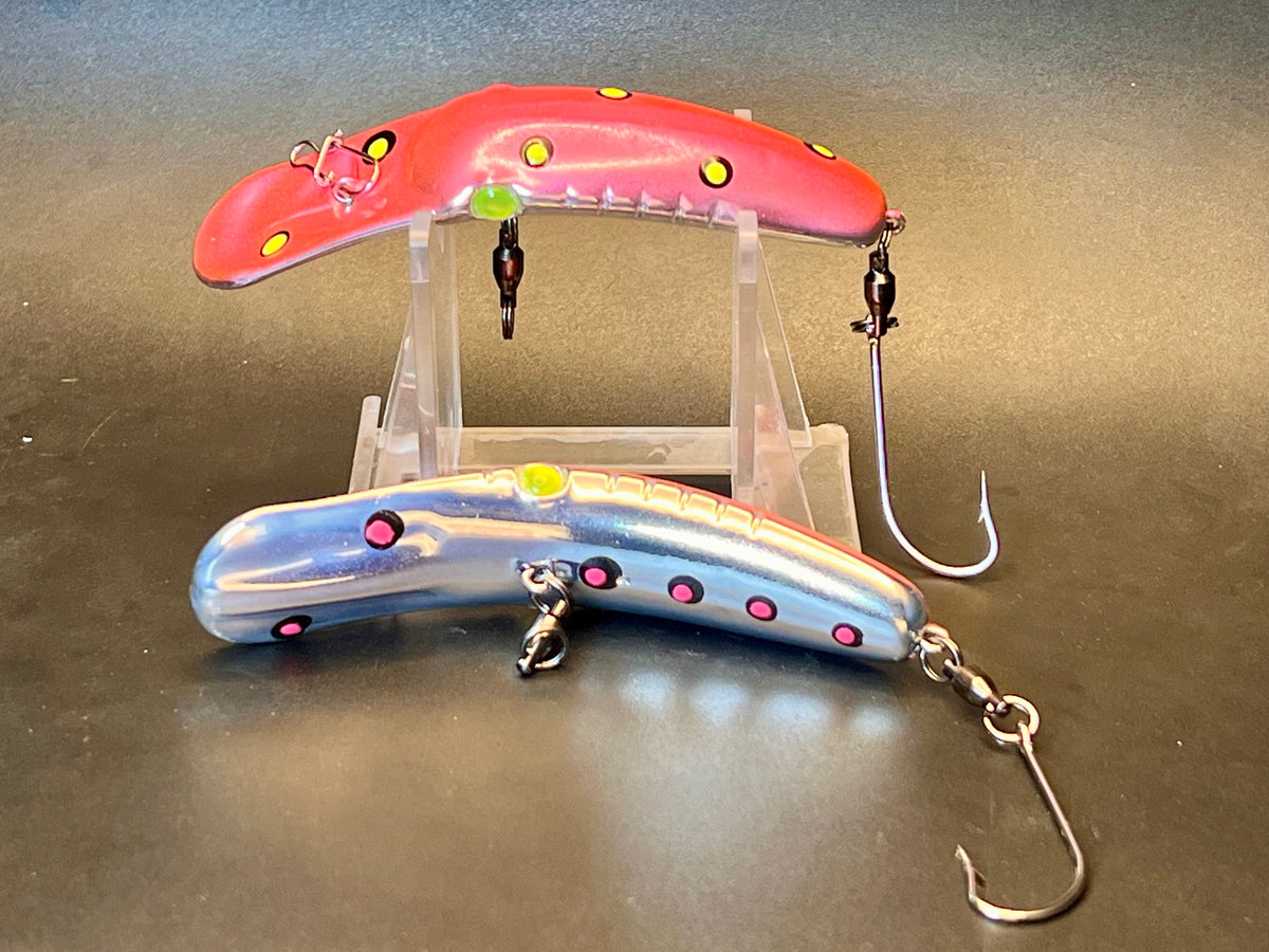 Pair of fishing lure plugs, one red-pink and one blue, with treble hooks