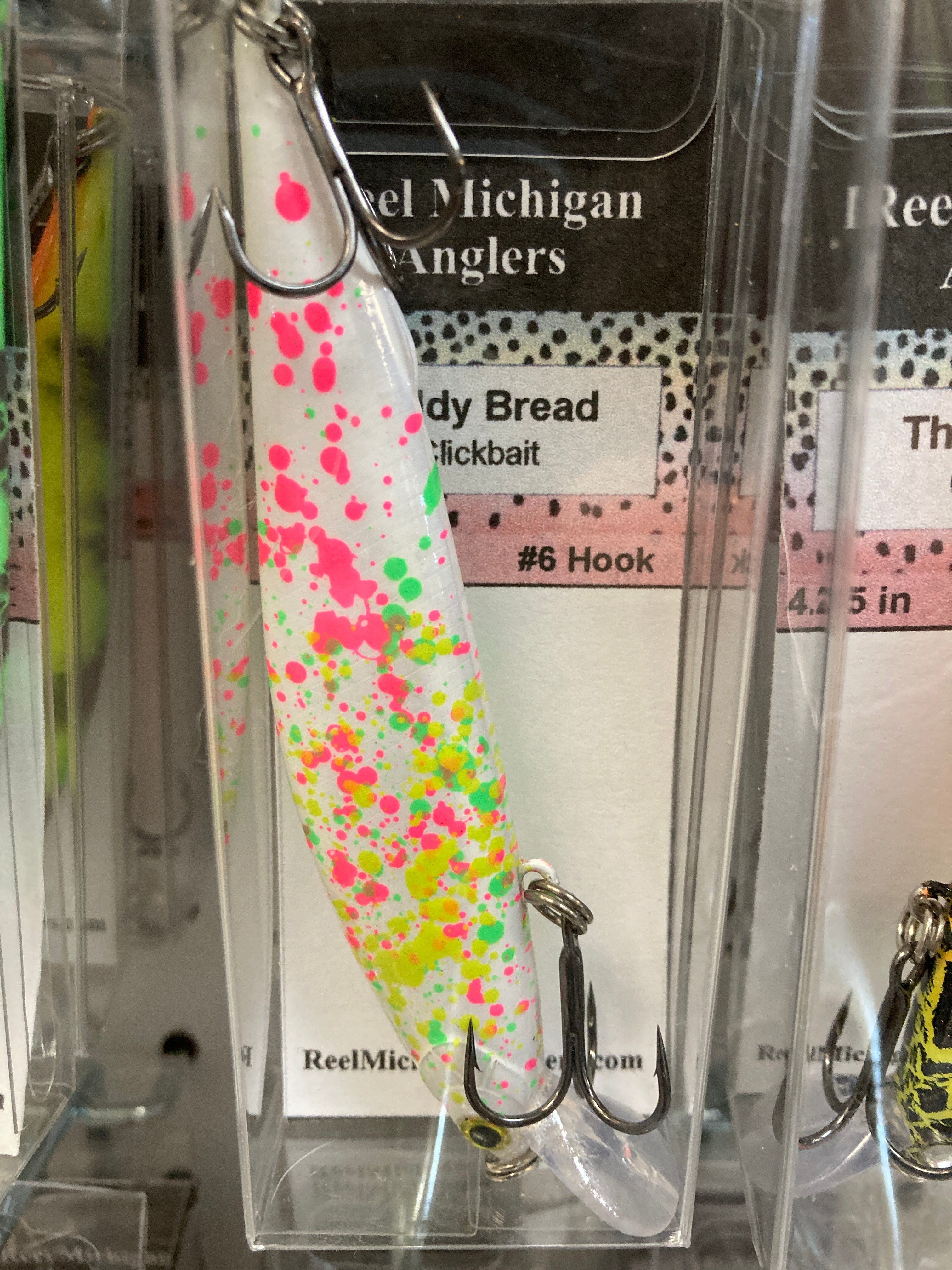 White fishing lure with multicolor speckle dots, treble hooks, 4.25 in.