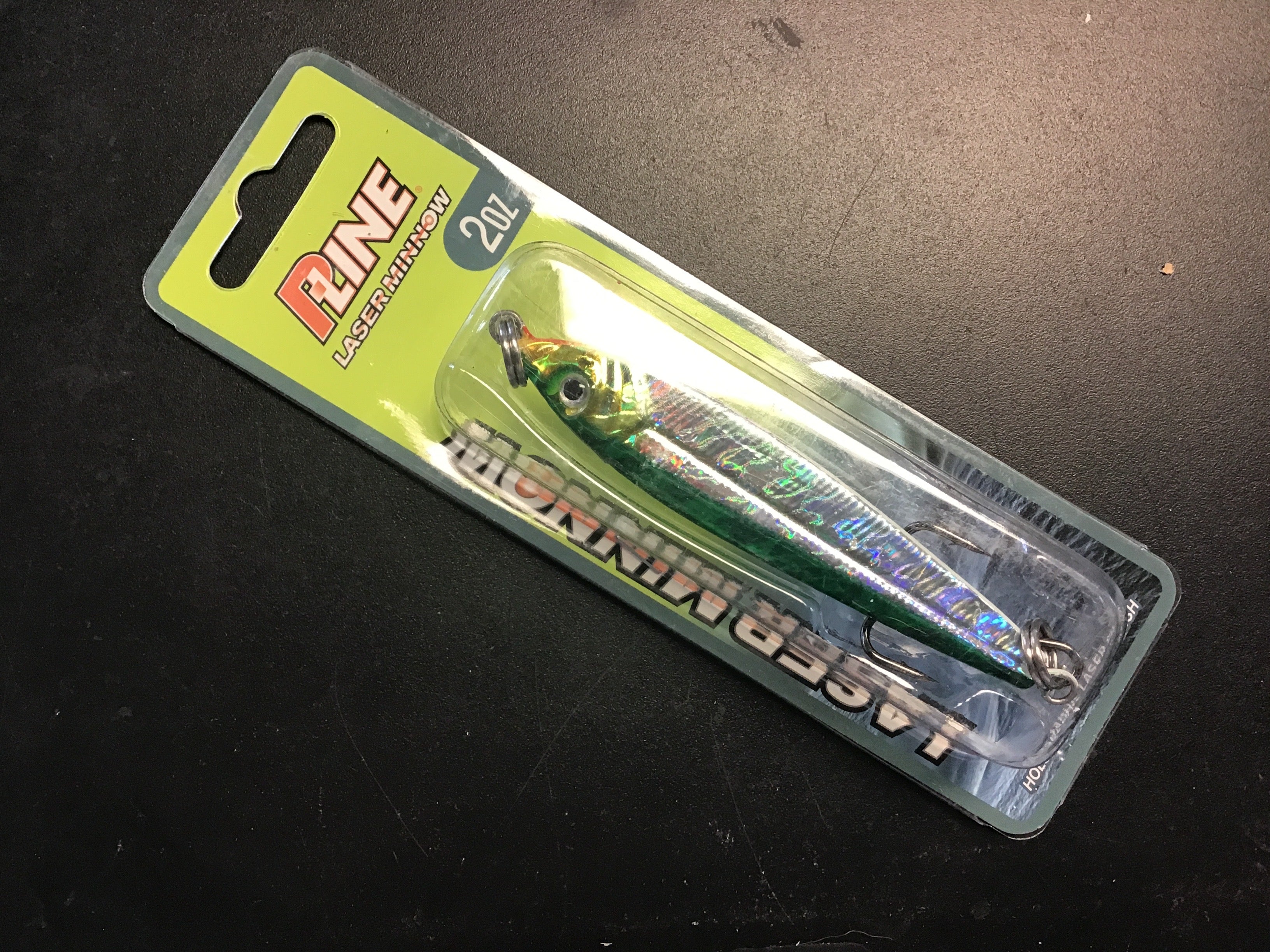 Holographic green and silver jigging spoon with dark top and chrome hook