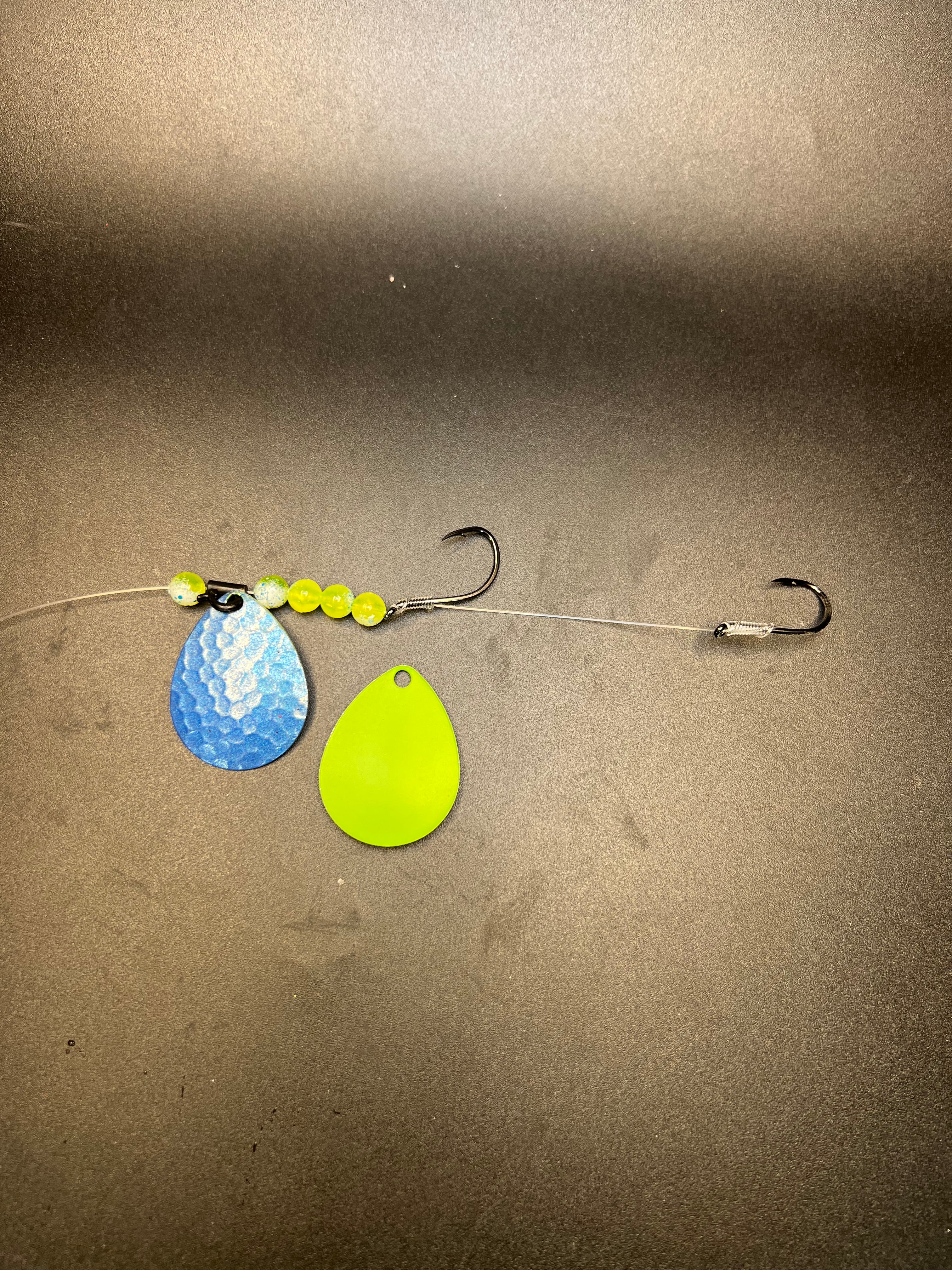 Fishing lure harness with blue and lime teardrop blades, bead chain, two hooks