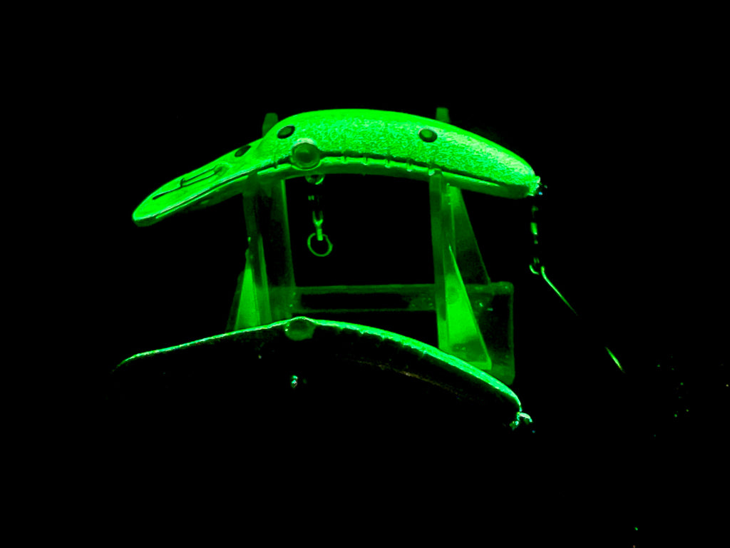 Glow fishing lure plug, bright green body with treble hooks