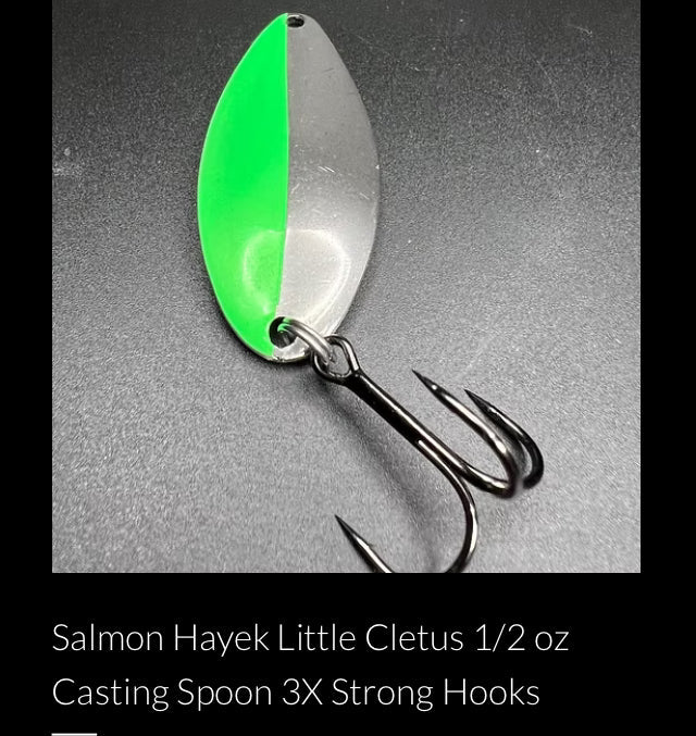 Green and silver casting spoon with three treble hooks and metal ring