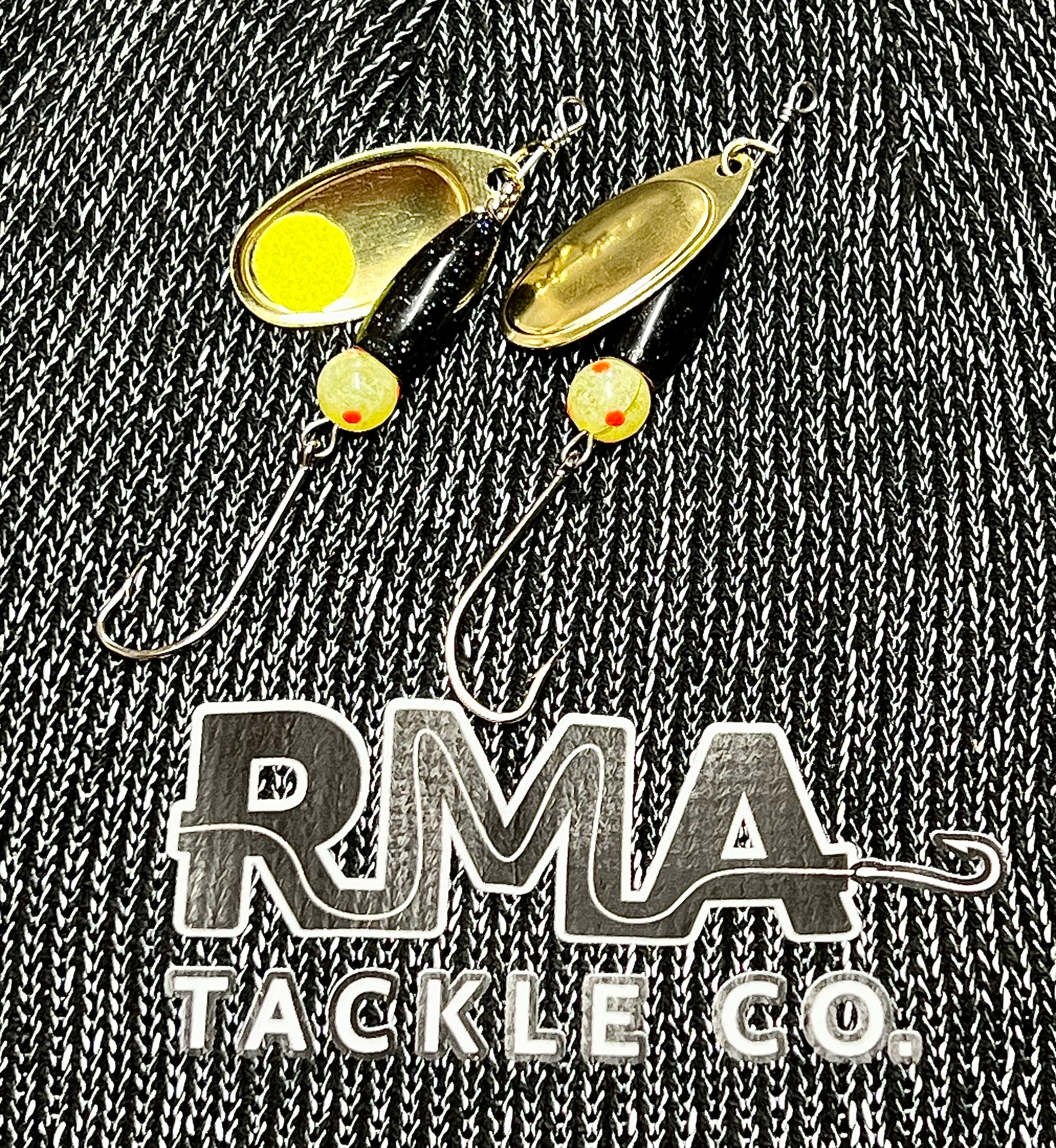 Inline spinner lure with gold chrome spoon, black body, yellow and red dot beads