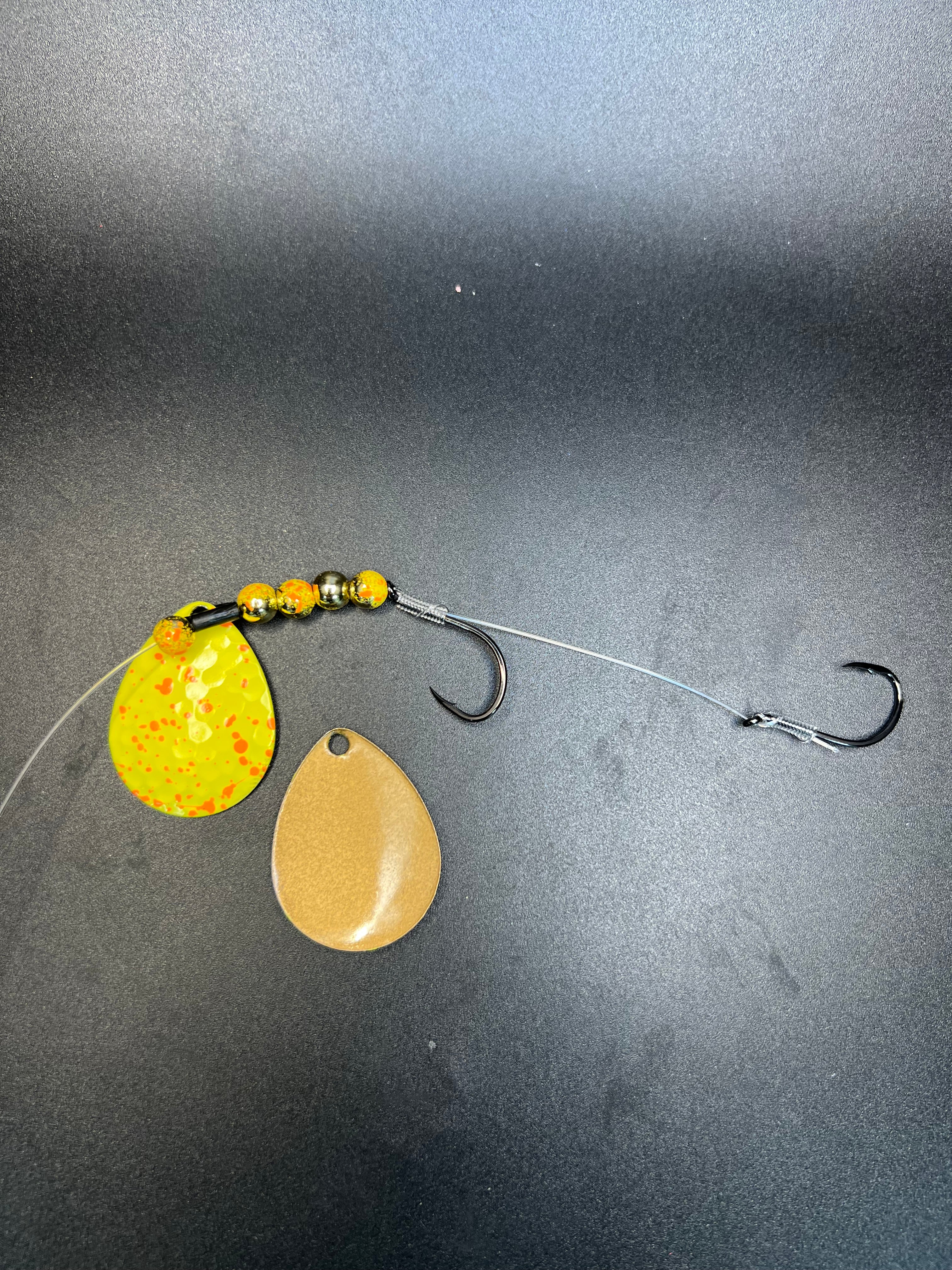 Fishing lure harness with gold and yellow spinner blades, beads, and two hooks