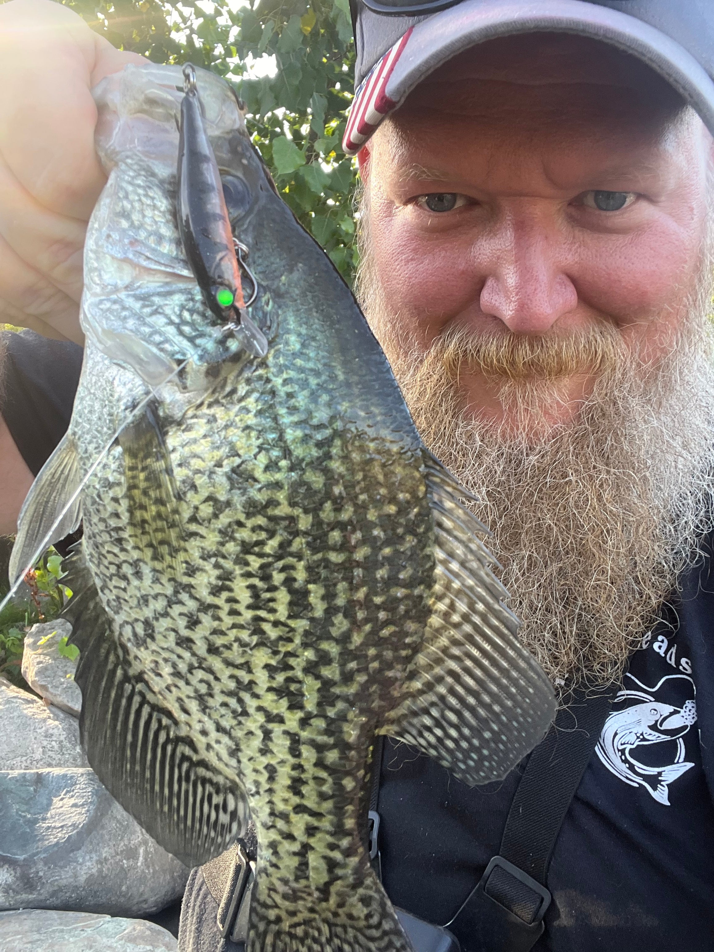Green-gold speckled jerkbait lure with silver fins and a front treble hook