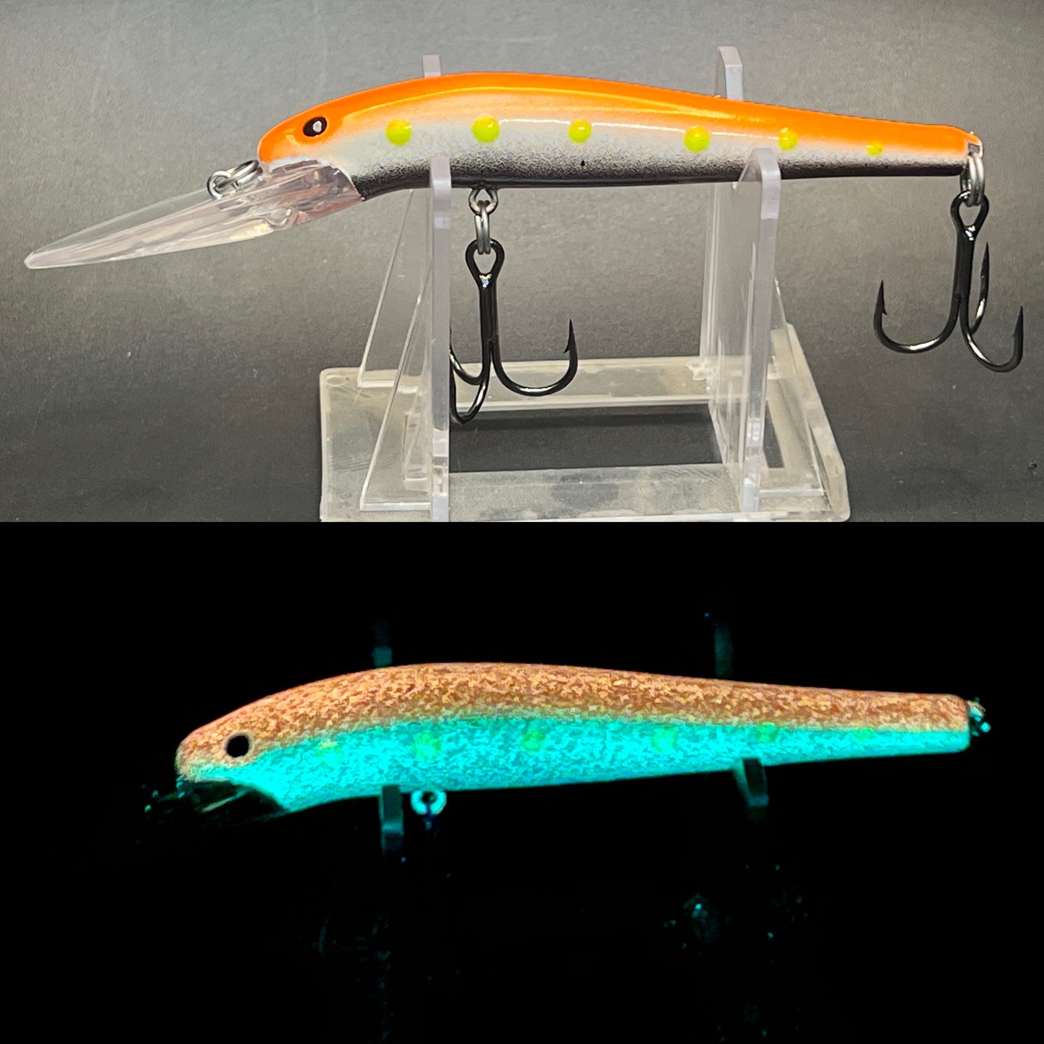 Glow fishing lure, orange and white body with yellow dots, two black treble hooks