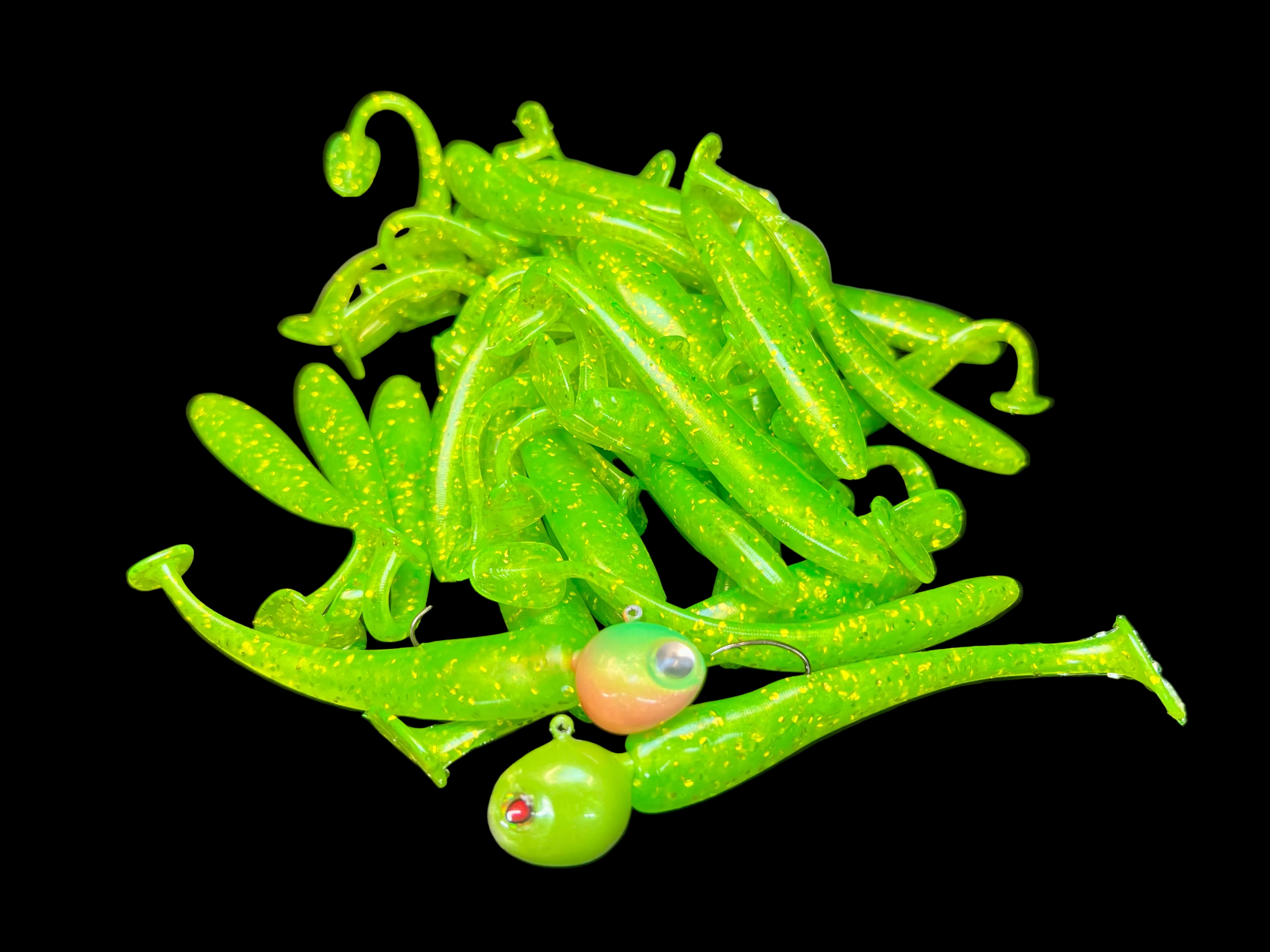 Green paddle tail swimbait assortment with jig heads and translucent bodies