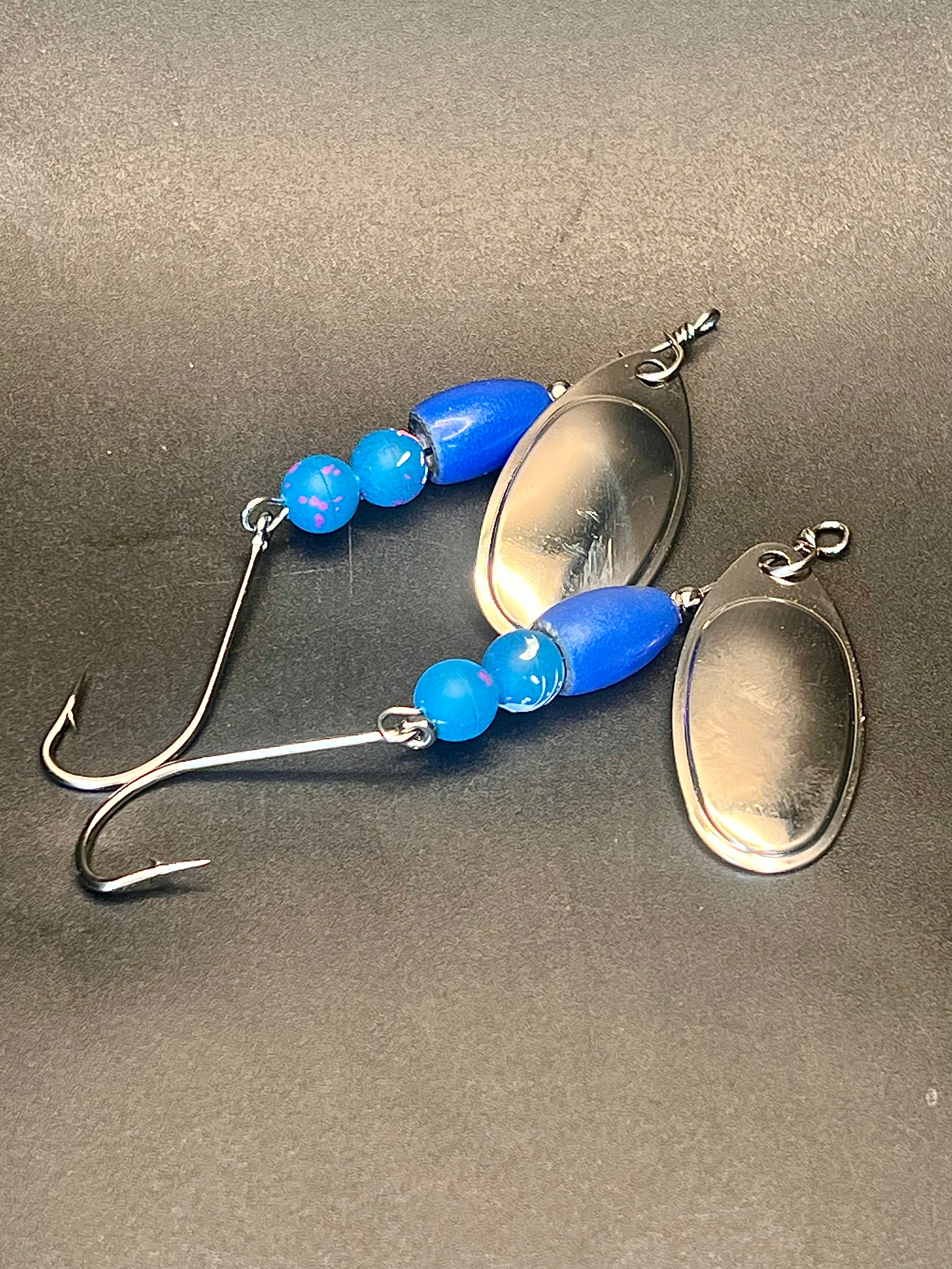 Blue inline spinner fishing lure with oval silver blade, beads, and two treble hooks
