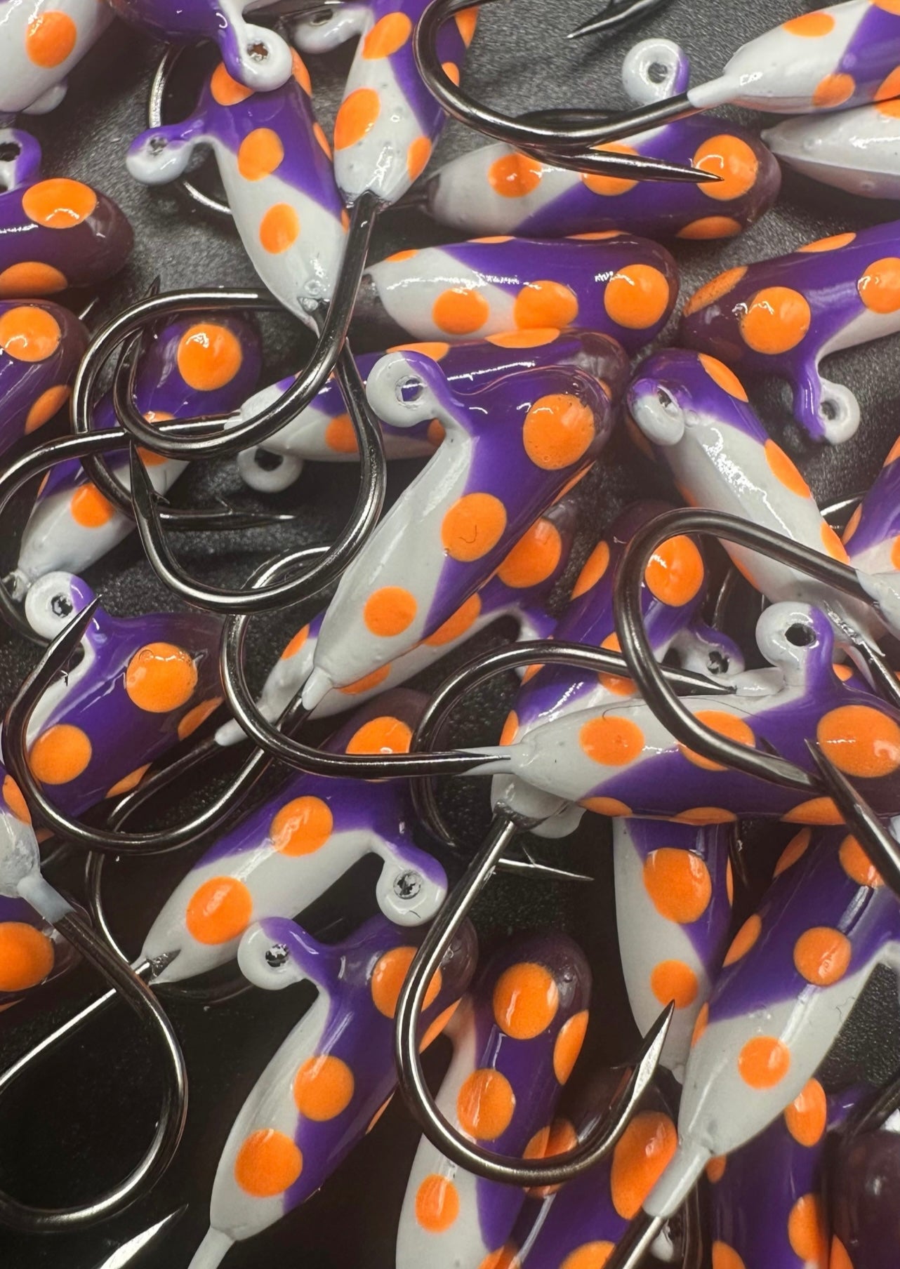Purple-and-white tube jigs with orange dots and Voodoo #4 hooks