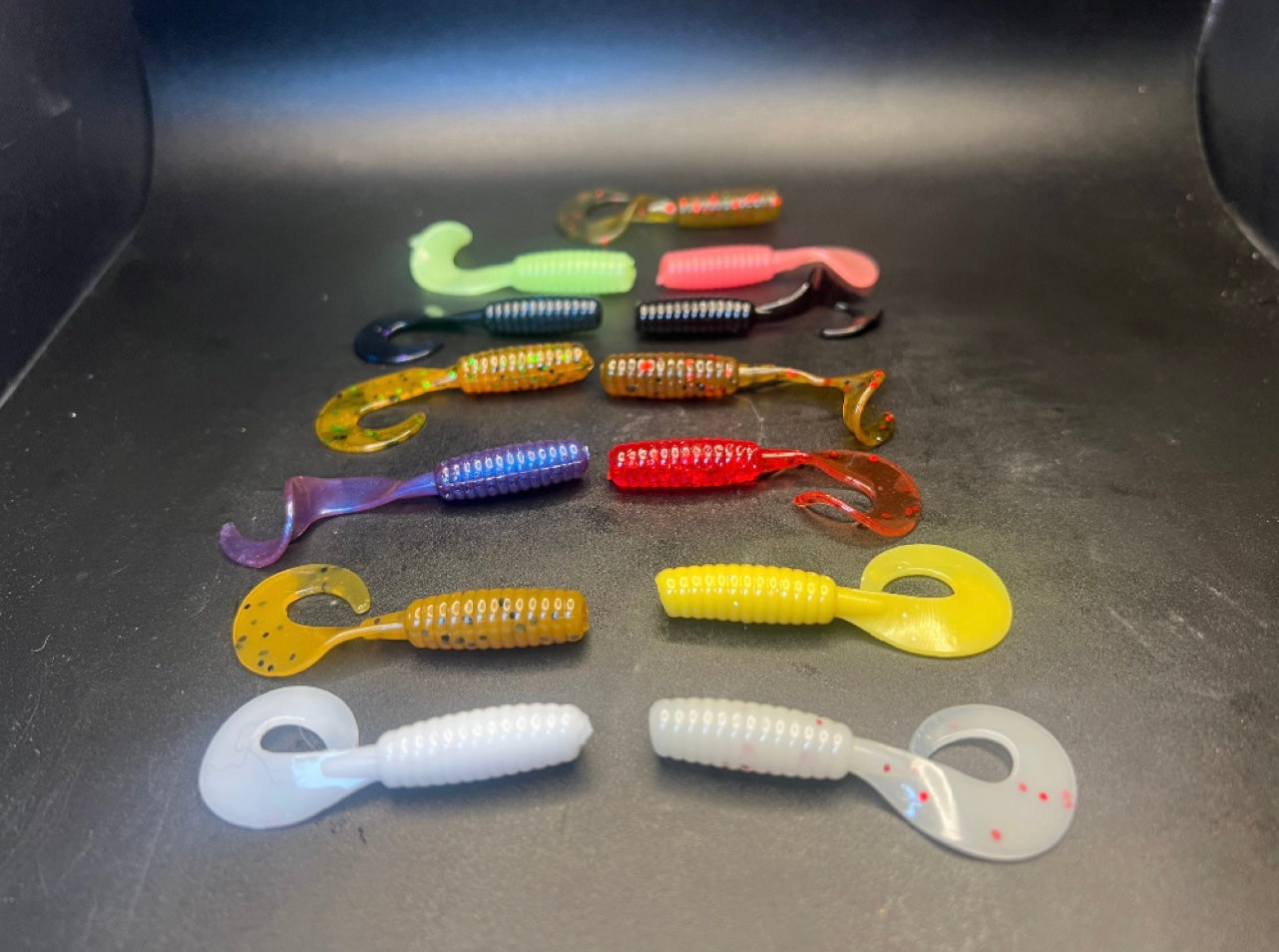 Curly Twister tail grubs in assorted colors: green, purple, red, yellow, white, dark/blue