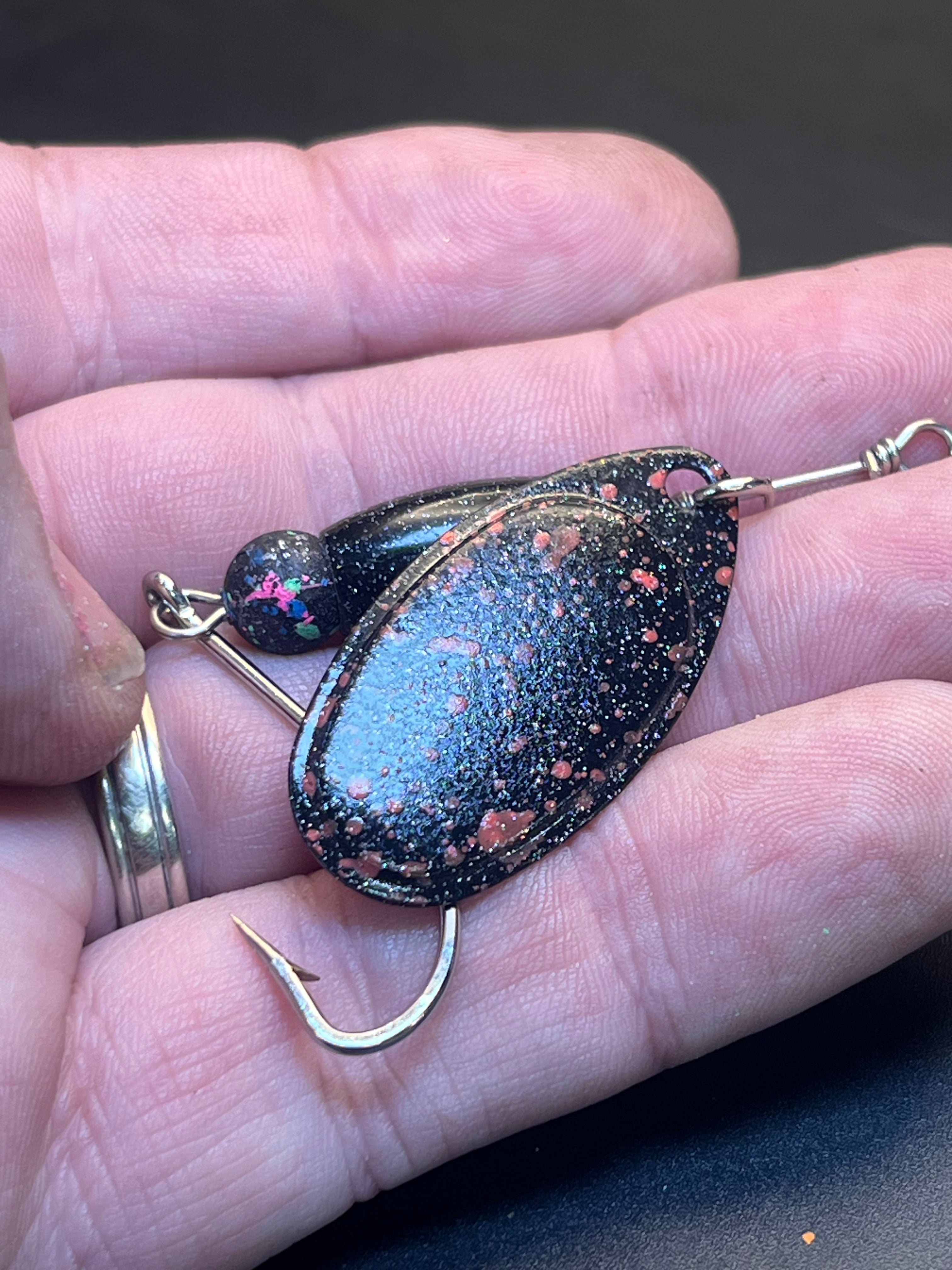 Small glitter inline spinner lure with dark-blue body and treble hook
