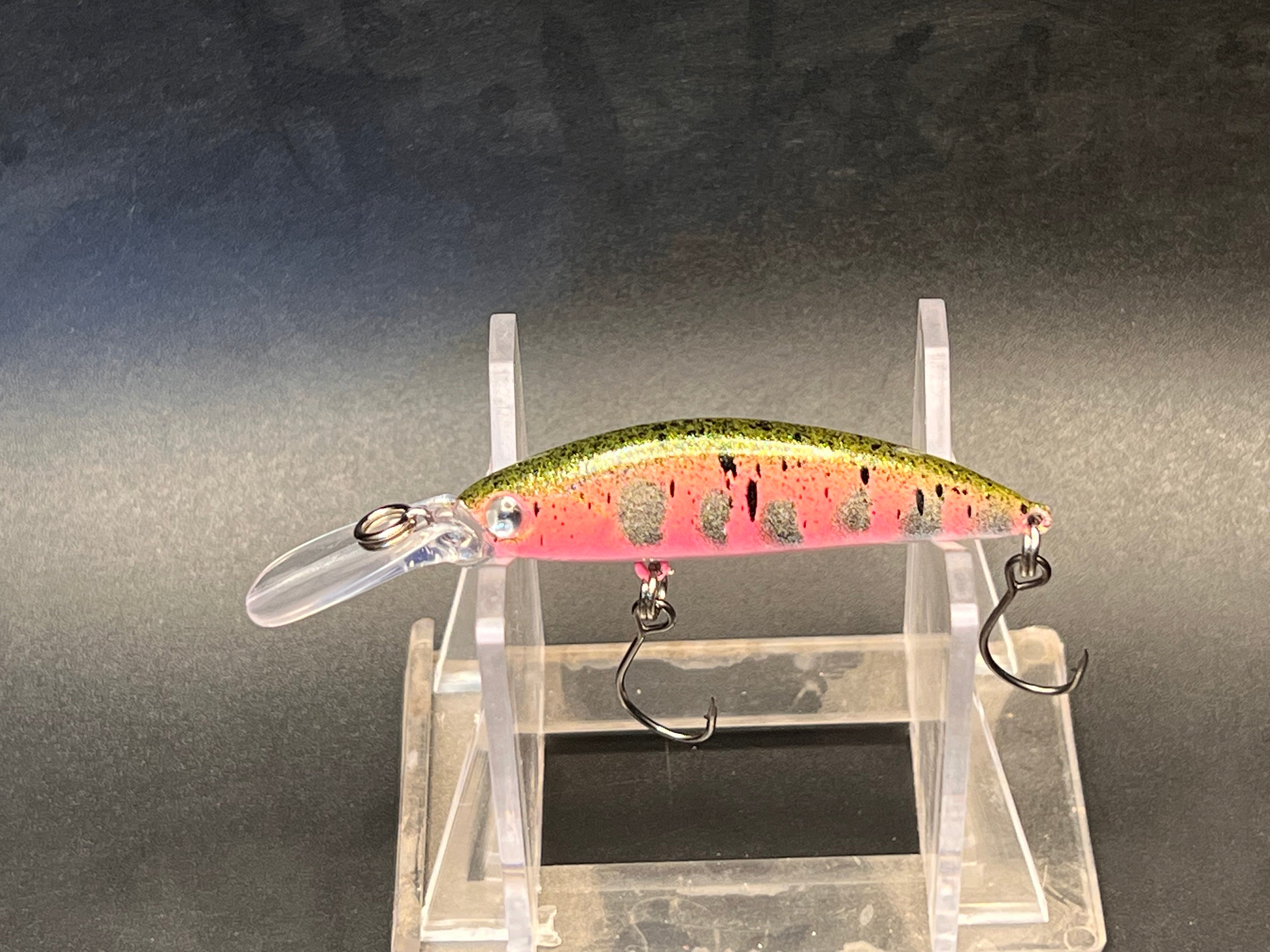 Smoltinator micro deep-sinking jerkbait with a pink belly, green spotted back, clear bill and treble hooks