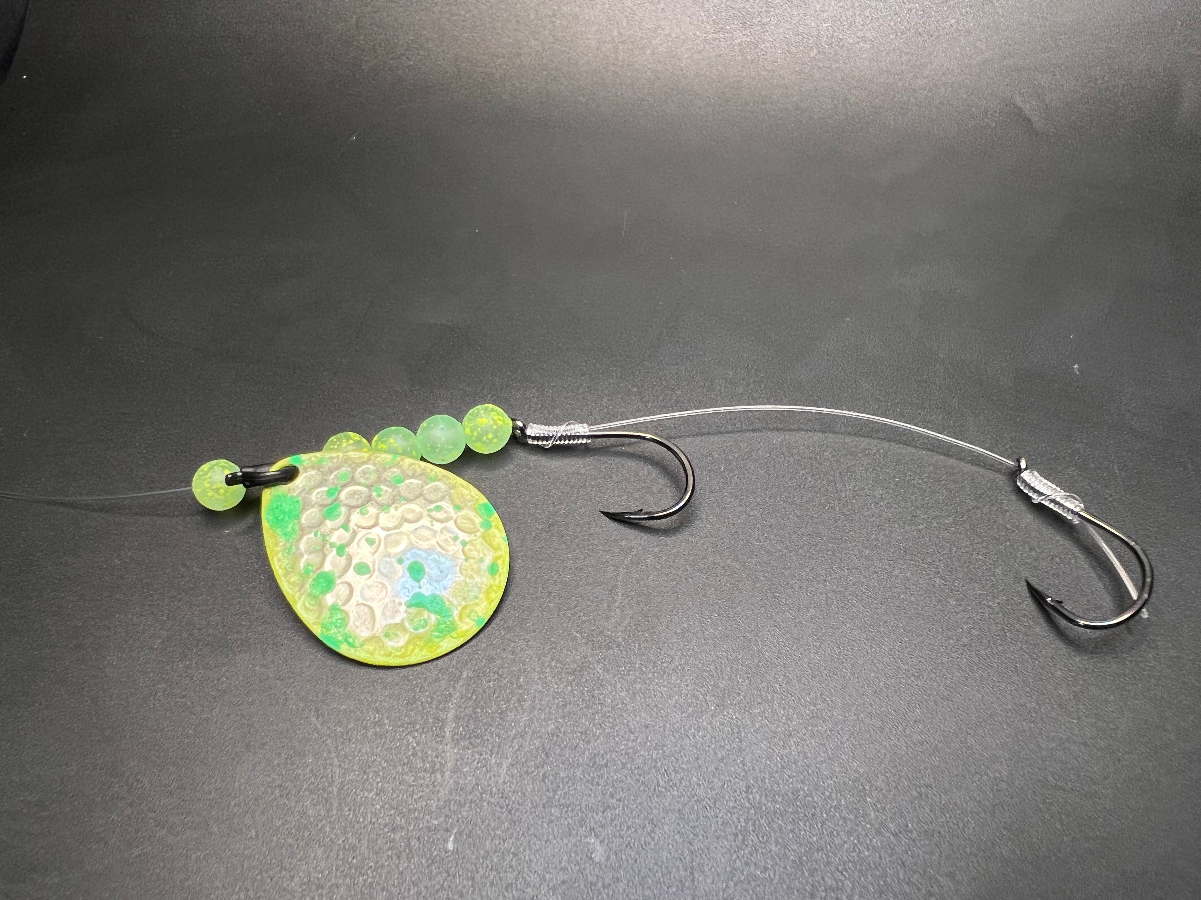 Fishing lure crawler harness with bright green spinner blade and two metal treble hooks