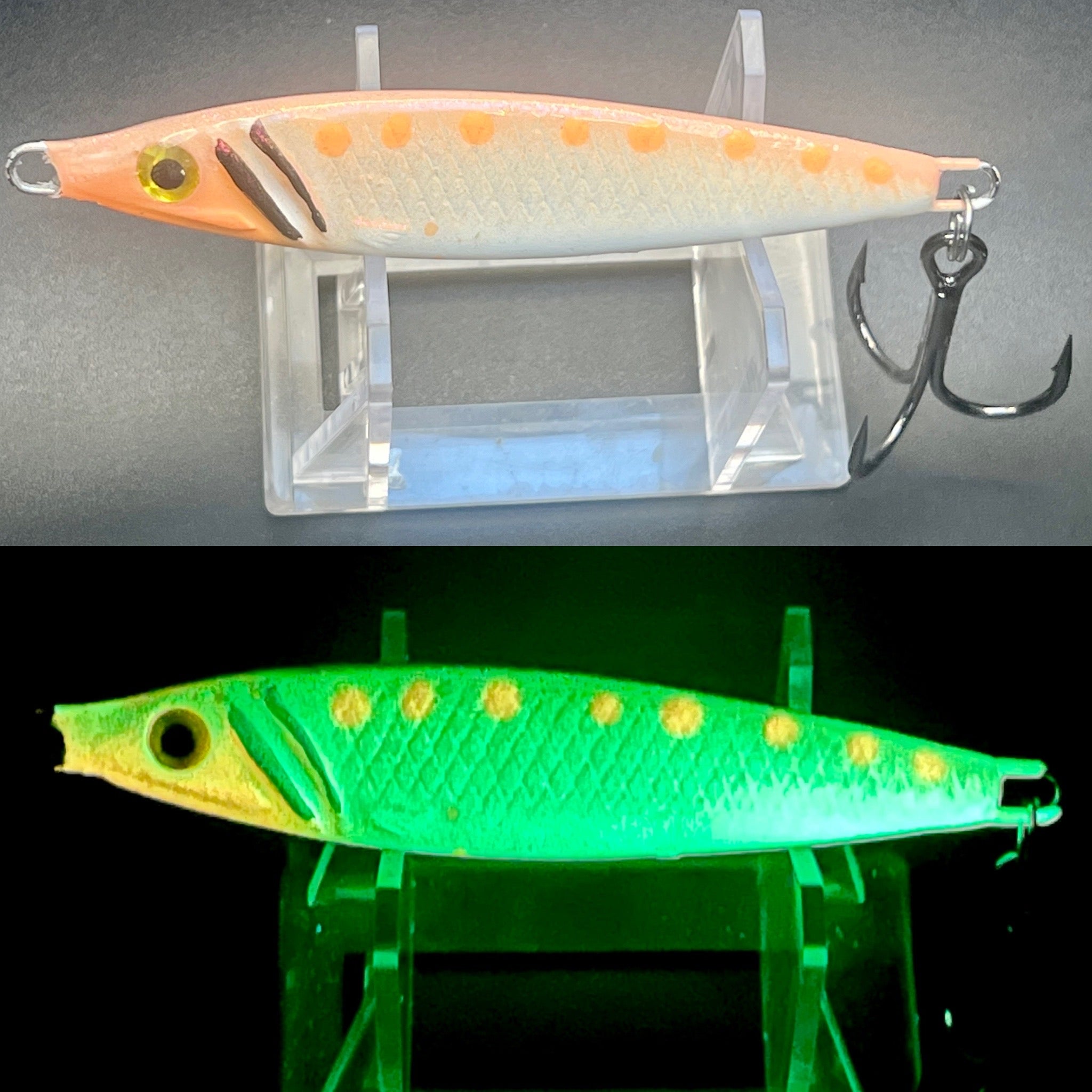 Jigging spoon lure, orange and white with green UV glow and treble hook