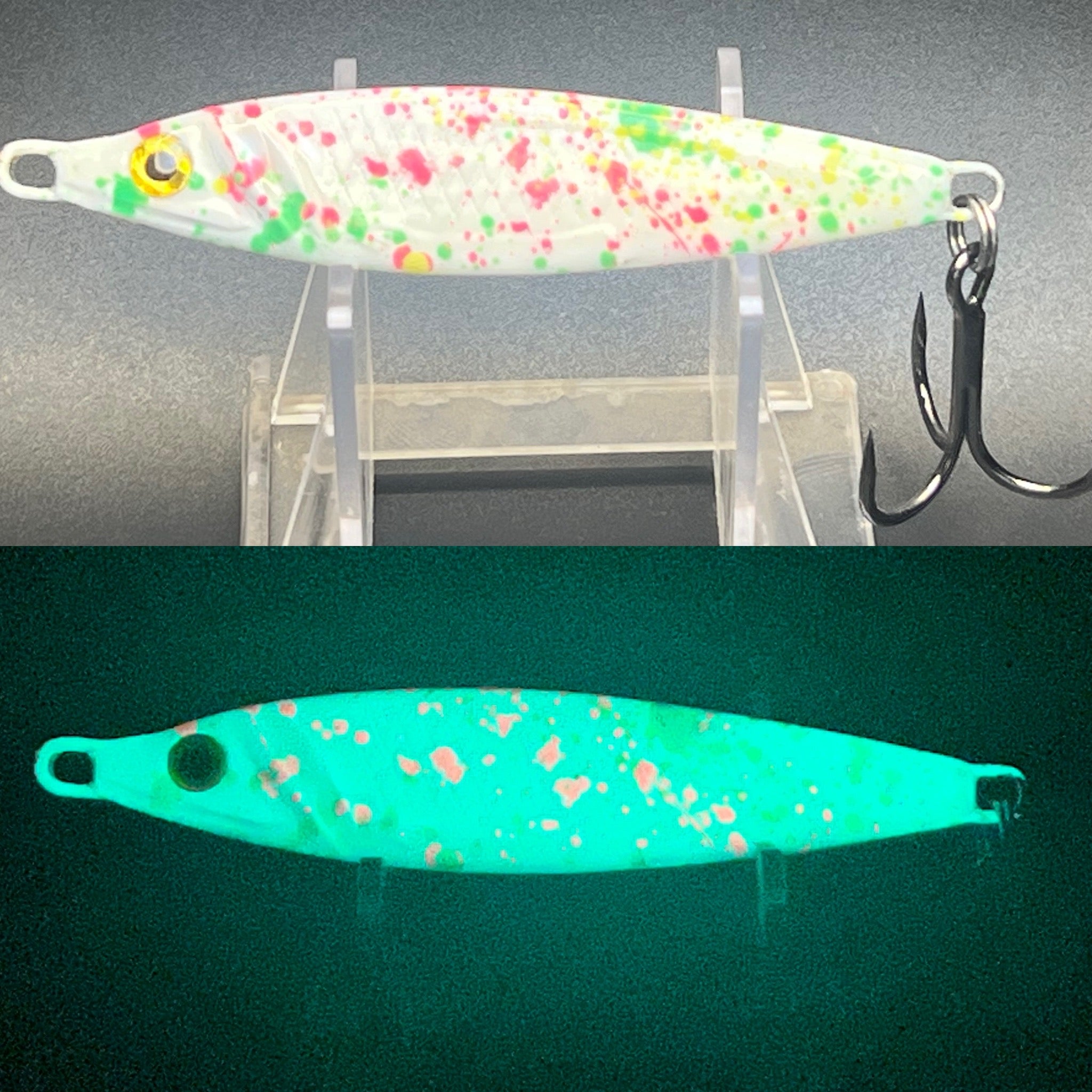 Fishing jigging spoon with white body, pink and green speckles, curved metal hook