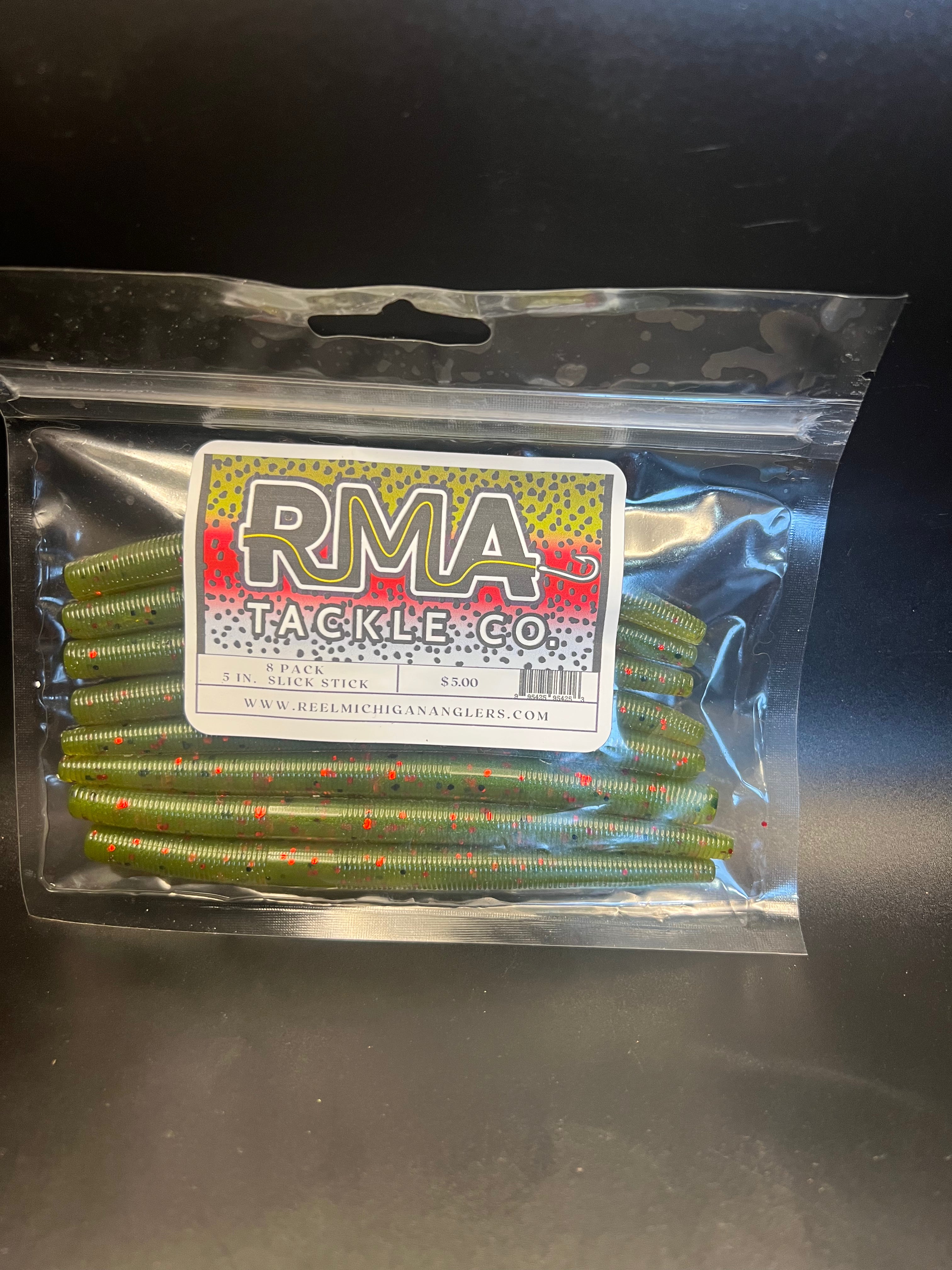 Soft plastic stickbait worms in green-yellow with red speckles inside clear pack