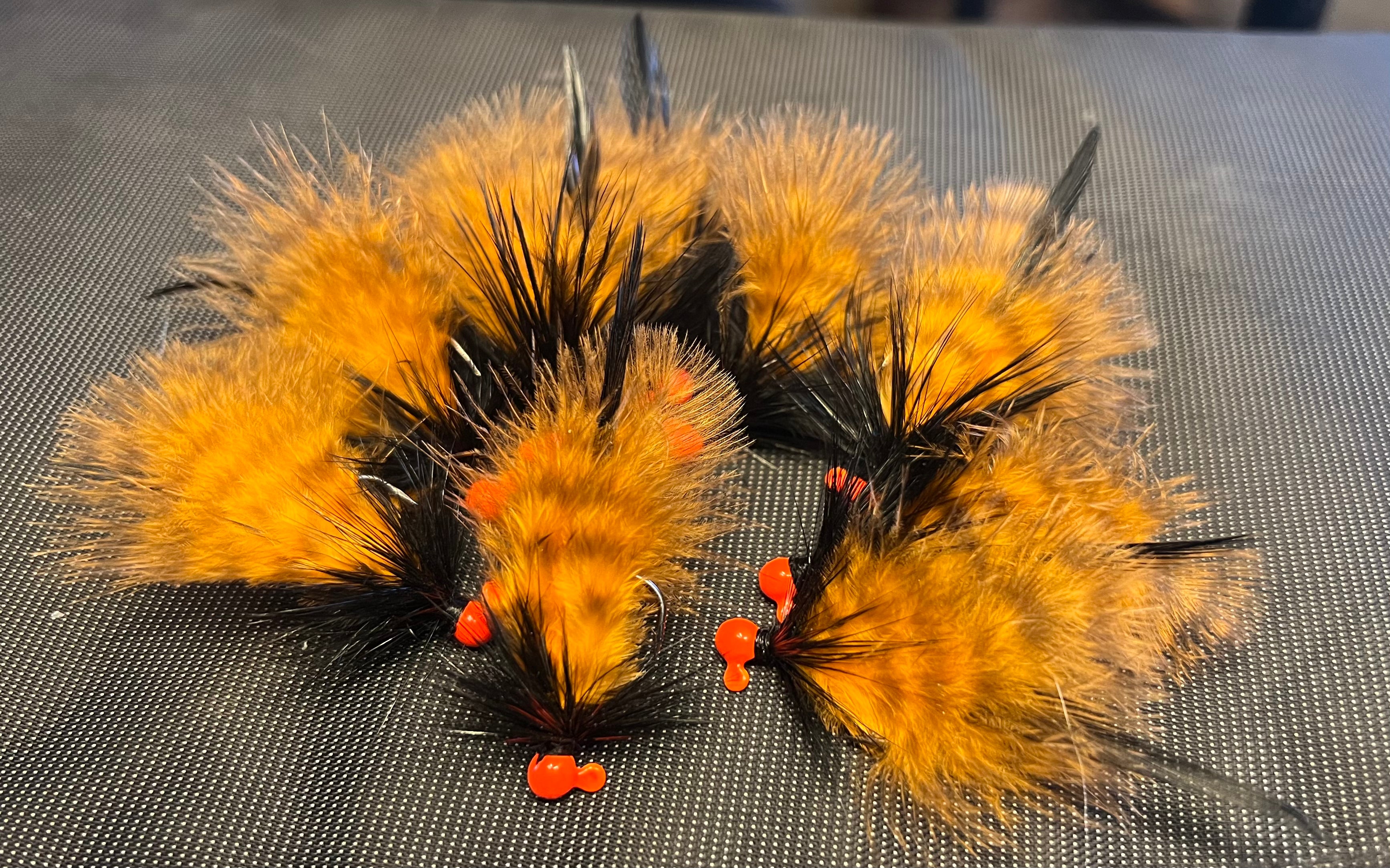 Set of marabou steelhead jigs, orange feathers with black accents and red beads
